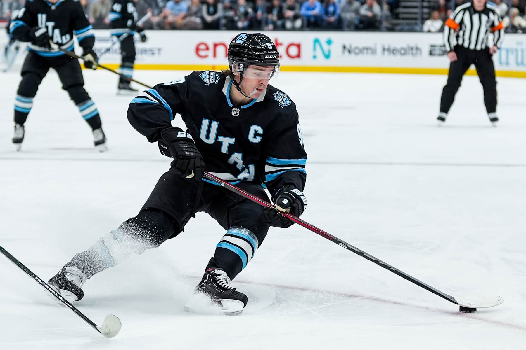 SALT LAKE CITY , UTAH - DECEMBER 10: Clayton Keller #9 of the Utah Hockey Club skates with the puck during the first period against the Minnesota Wild on December 10, 2024 at Delta Center in Salt Lake City, Utah.  (Photo by Hunter Dyke/NHLI via Getty Images)