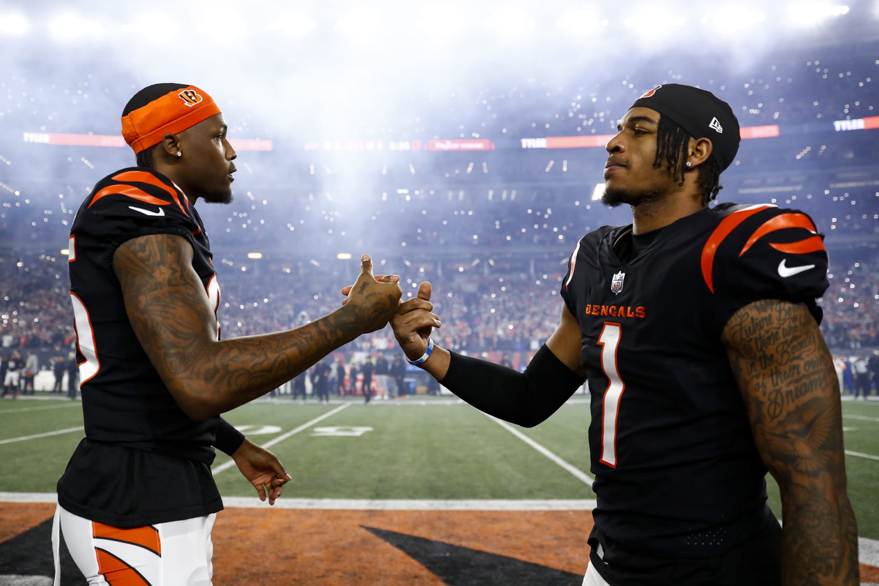 CINCINNATI, OH - JANUARY 2: Tee Higgins #85 of the Cincinnati Bengals high fives Ja'Marr Chase #1 on the field prior to an NFL football game against the Buffalo Bills at Paycor Stadium on January 2, 2023 in Cincinnati, Ohio. (Photo by Kevin Sabitus/Getty Images)