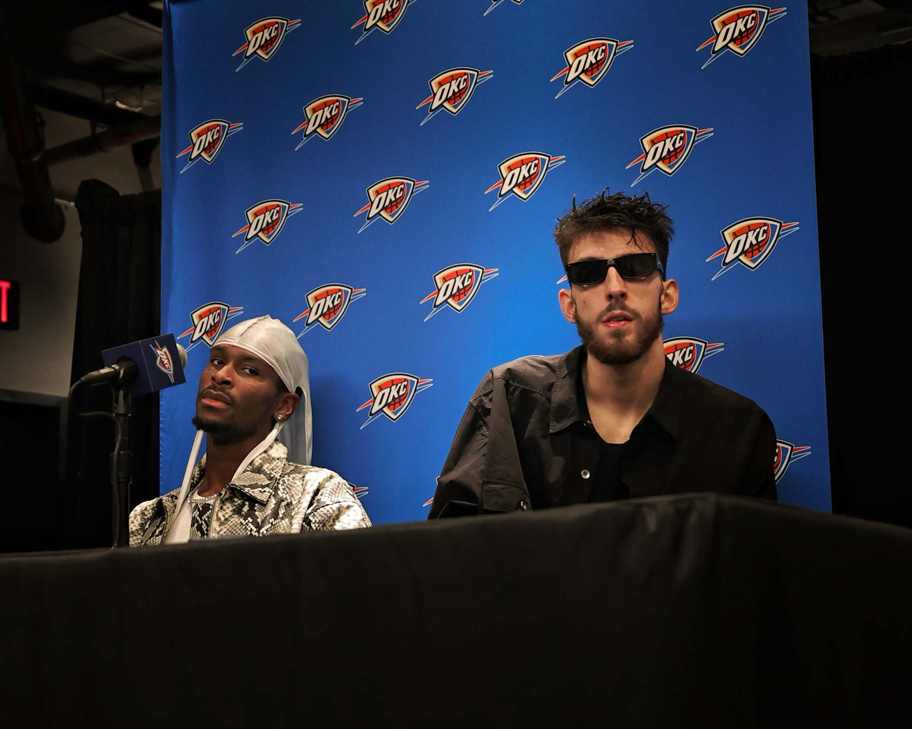 INGLEWOOD, CA - NOVEMBER 2: Shai Gilgeous-Alexander #2 and Chet Holmgren #7 of the Oklahoma City Thunder look on during a press conference after the game against the LA Clippers on November 2, 2024 at Intuit Dome in Los Angeles, California. NOTE TO USER: User expressly acknowledges and agrees that, by downloading and/or using this Photograph, user is consenting to the terms and conditions of the Getty Images License Agreement. Mandatory Copyright Notice: Copyright 2024 NBAE (Photo by Jim Poorten/NBAE via Getty Images)