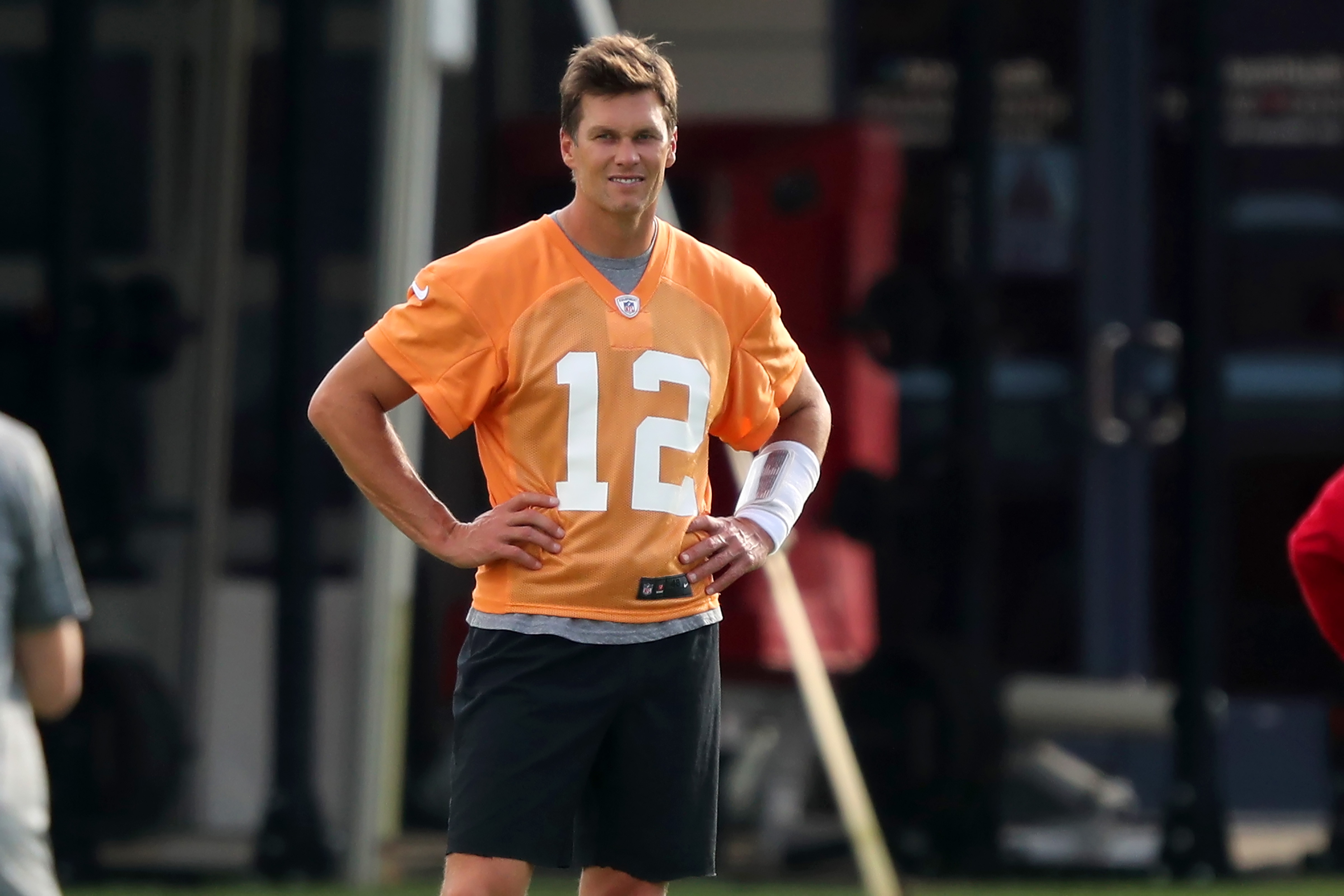 TAMPA, FL - JUL 28: Tom Brady (12) smiles as he watches the action on the field during the Tampa Bay Buccaneers Training Camp on July 28, 2021 at the AdventHealth Training Center at One Buccaneer Place in Tampa, Florida. (Photo by Cliff Welch/Icon Sportswire via Getty Images)
