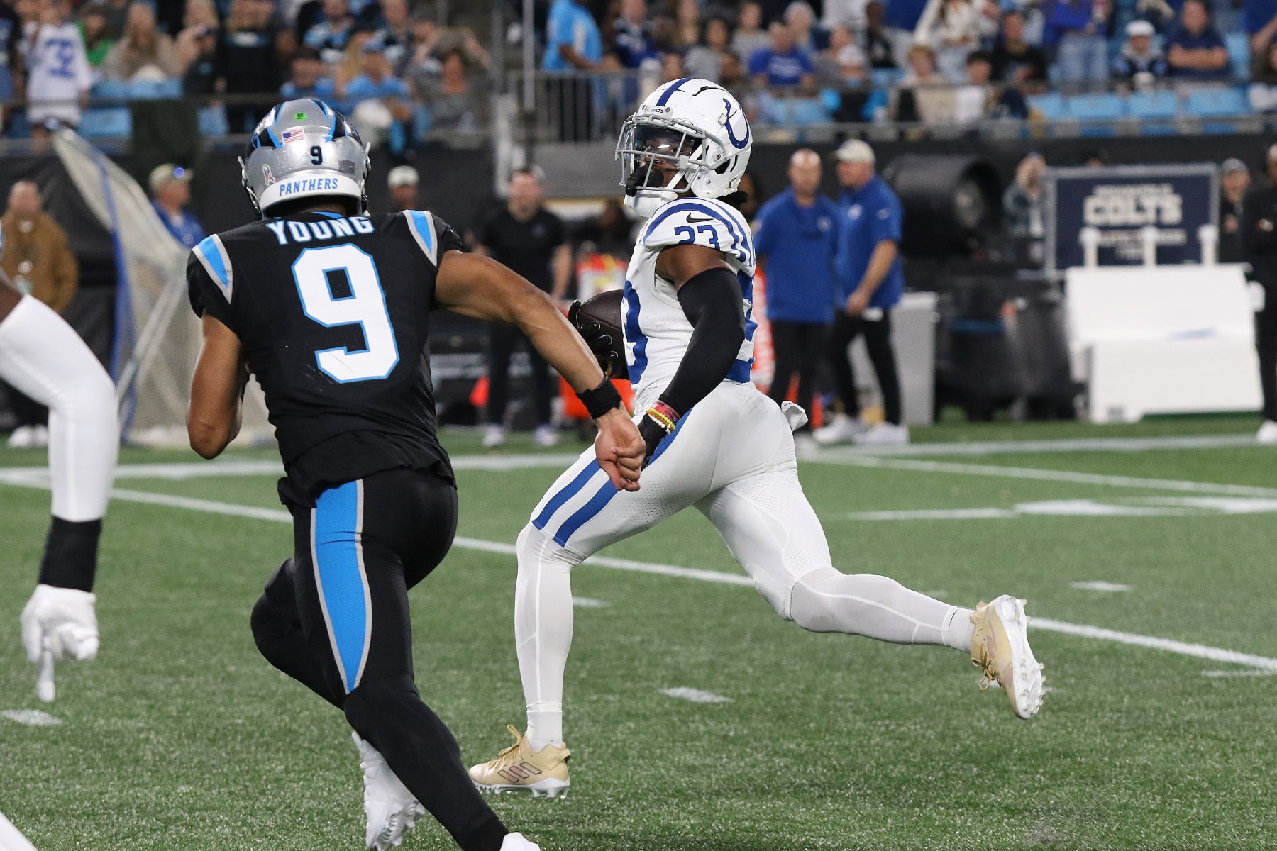 CHARLOTTE, NC - NOVEMBER 05: Indianapolis Colts corner back Kenny Moore (23) looks back at Carolina Panthers quarterback Bryce Young (9)  as he runs an interception back for a touchdown during a NFL football game between the Indianapolis Colts and the Carolina Panthers on November 5, 2023 at Bank of America Stadium in Charlotte, N.C.(Photo by John Byrum/Icon Sportswire via Getty Images)