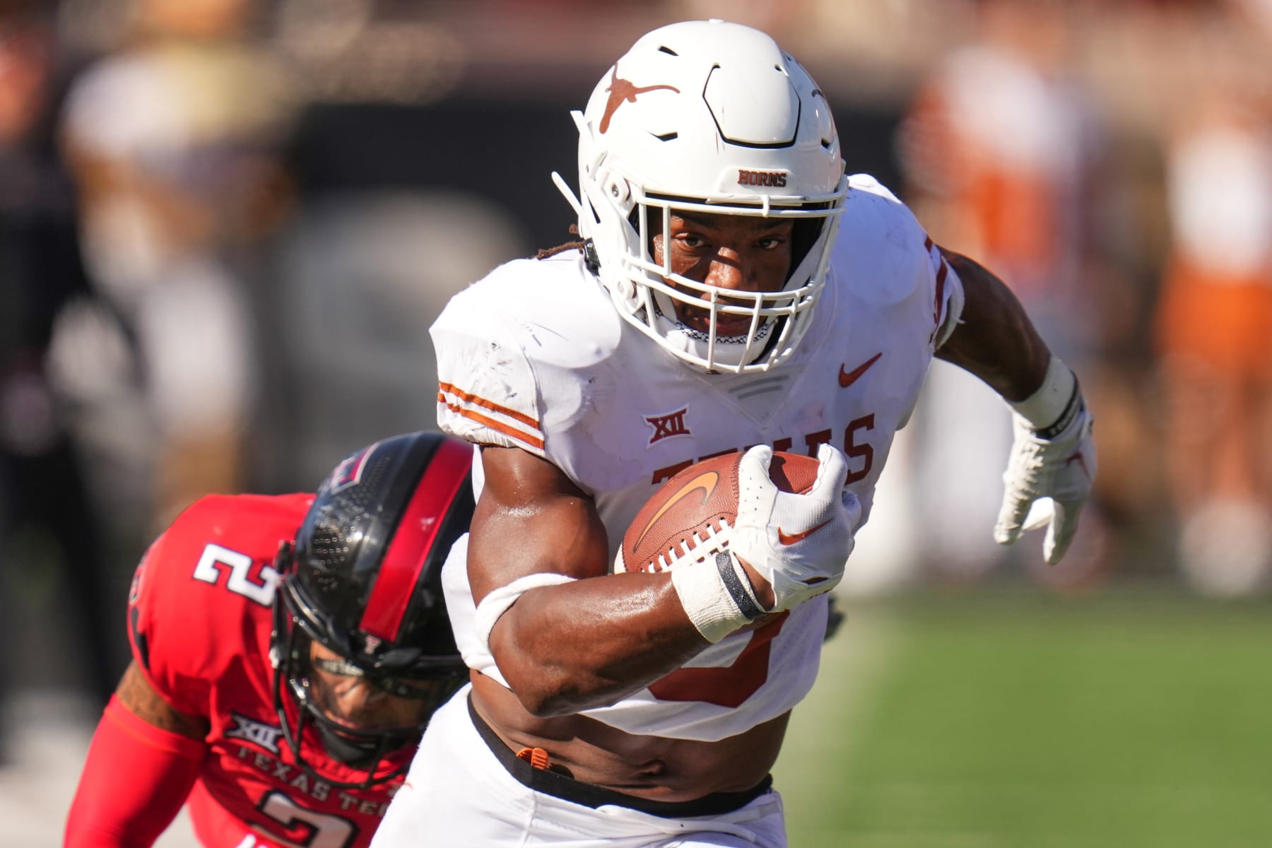 LUBBOCK, TEXAS - SEPTEMBER 24: Bijan Robinson #5 of the Texas Longhorns rushes for a touchdown ahead of Reggie Pearson Jr. #2 of the Texas Tech Red Raiders at Jones AT&T Stadium on September 24, 2022 in Lubbock, Texas. (Photo by Josh Hedges/Getty Images)