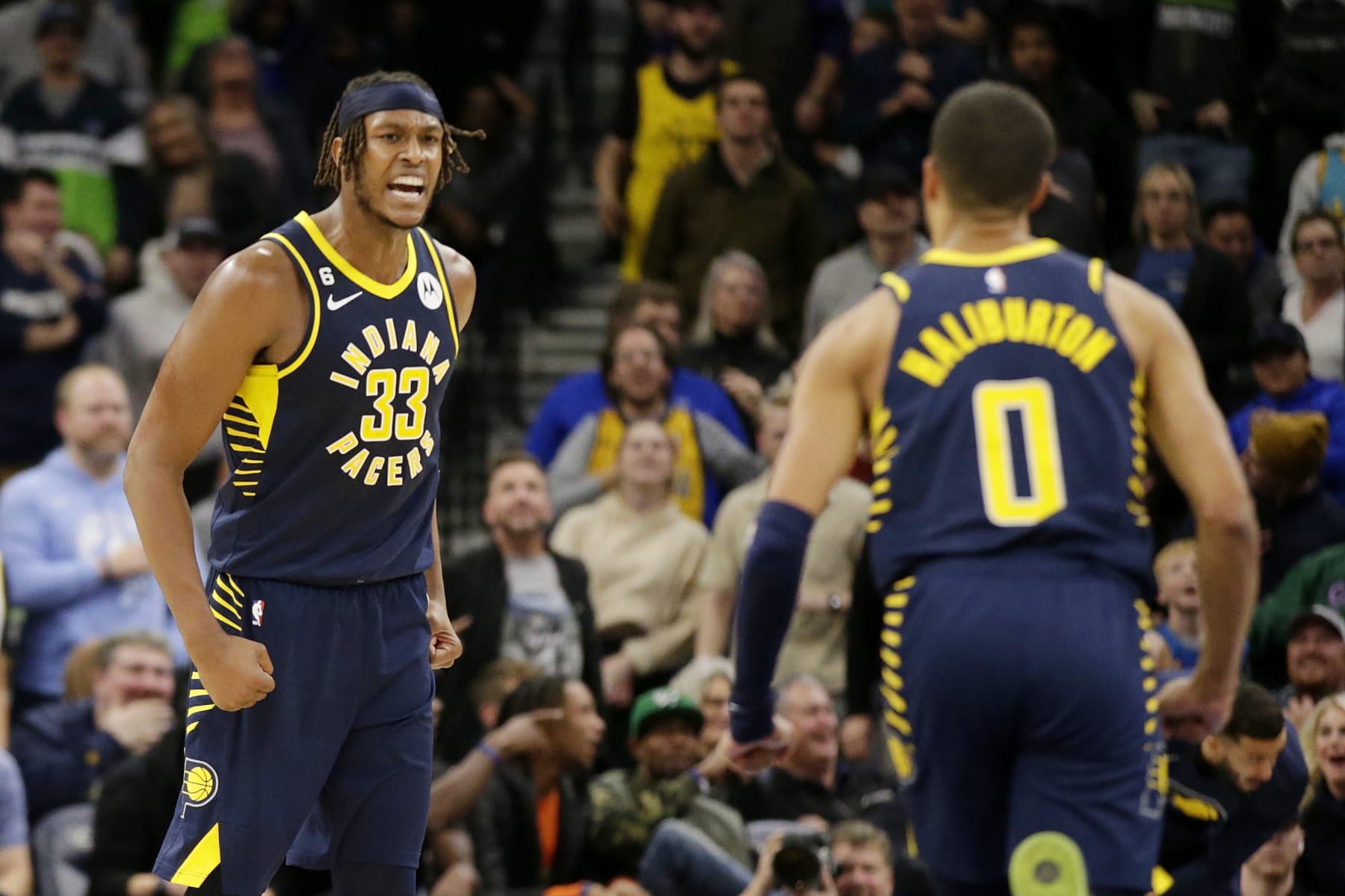 Indiana Pacers center Myles Turner (33) celebrates with Pacers guard Tyrese Haliburton (0) in the fourth quarter of an NBA basketball game against the Minnesota Timberwolve, Wednesday, Dec. 7, 2022, in Minneapolis. (AP Photo/Andy Clayton-King)