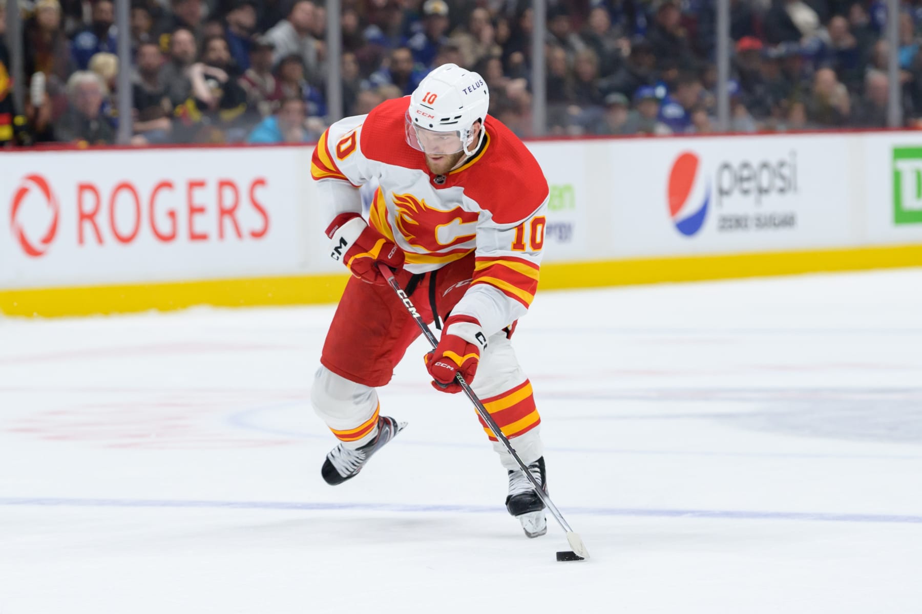 VANCOUVER, CANADA - APRIL 8: Jonathan Huberdeau #10 of the Calgary Flames skates with the puck in overtime during their NHL game against the Vancouver Canucks at Rogers Arena on April 8, 2023 in Vancouver, British Columbia, Canada. (Photo by Derek Cain/Getty Images)