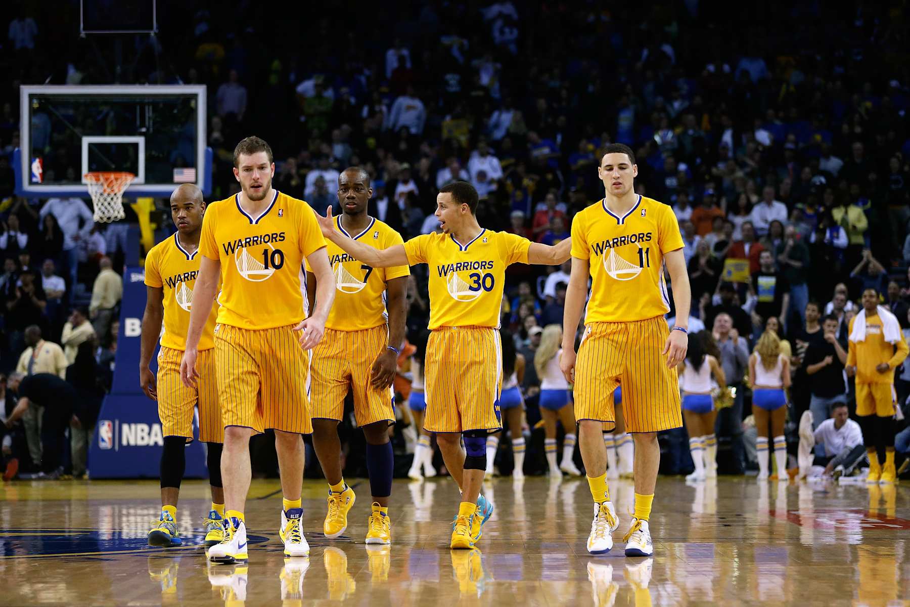 OAKLAND, CA - FEBRUARY 22:  Jarrett Jack #2, David Lee #10, Carl Landry #7, Klay Thompson #11, and Stephen Curry #30 of the Golden State Warriors walk on to the court during their game against the San Antonio Spurs at Oracle Arena on February 22, 2013 in Oakland, California. The Warriors are wearing new short-sleeved uniforms for the first time. The Warriors won the game in overtime.  NOTE TO USER: User expressly acknowledges and agrees that, by downloading and or using this photograph, User is consenting to the terms and conditions of the Getty Images License Agreement.  (Photo by Ezra Shaw/Getty Images) 