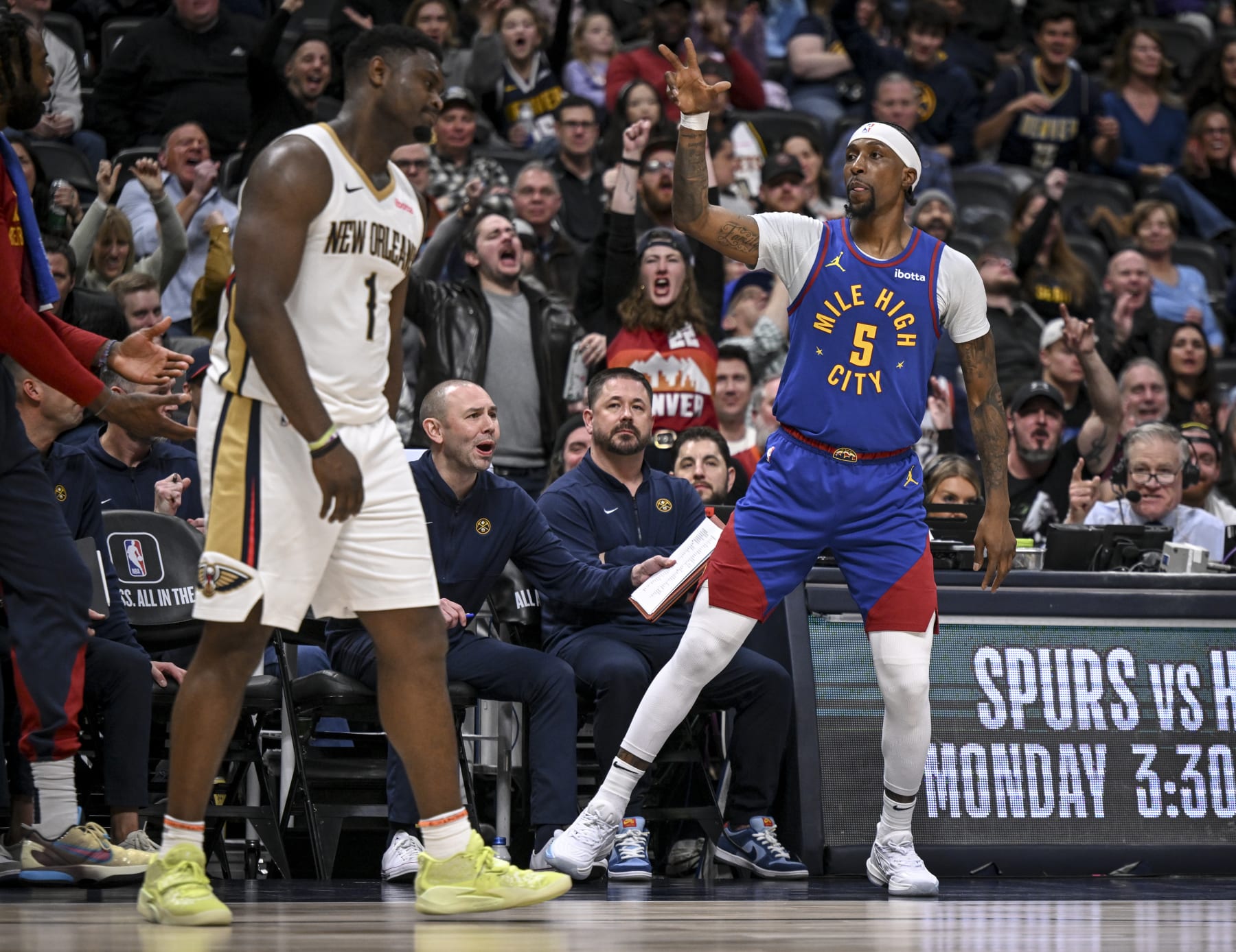 DENVER, CO - JANUARY 12: Kentavious Caldwell-Pope (5) of the Denver Nuggets lets Zion Williamson (1) of the New Orleans Pelicans know how many points the three pointer he made over him counted for as he raises three fingers in the traditional German fashion during the fourth quarter of the Nuggets' 125-113 win at Ball Arena in Denver on Friday, January 12, 2024. (Photo by AAron Ontiveroz/The Denver Post)