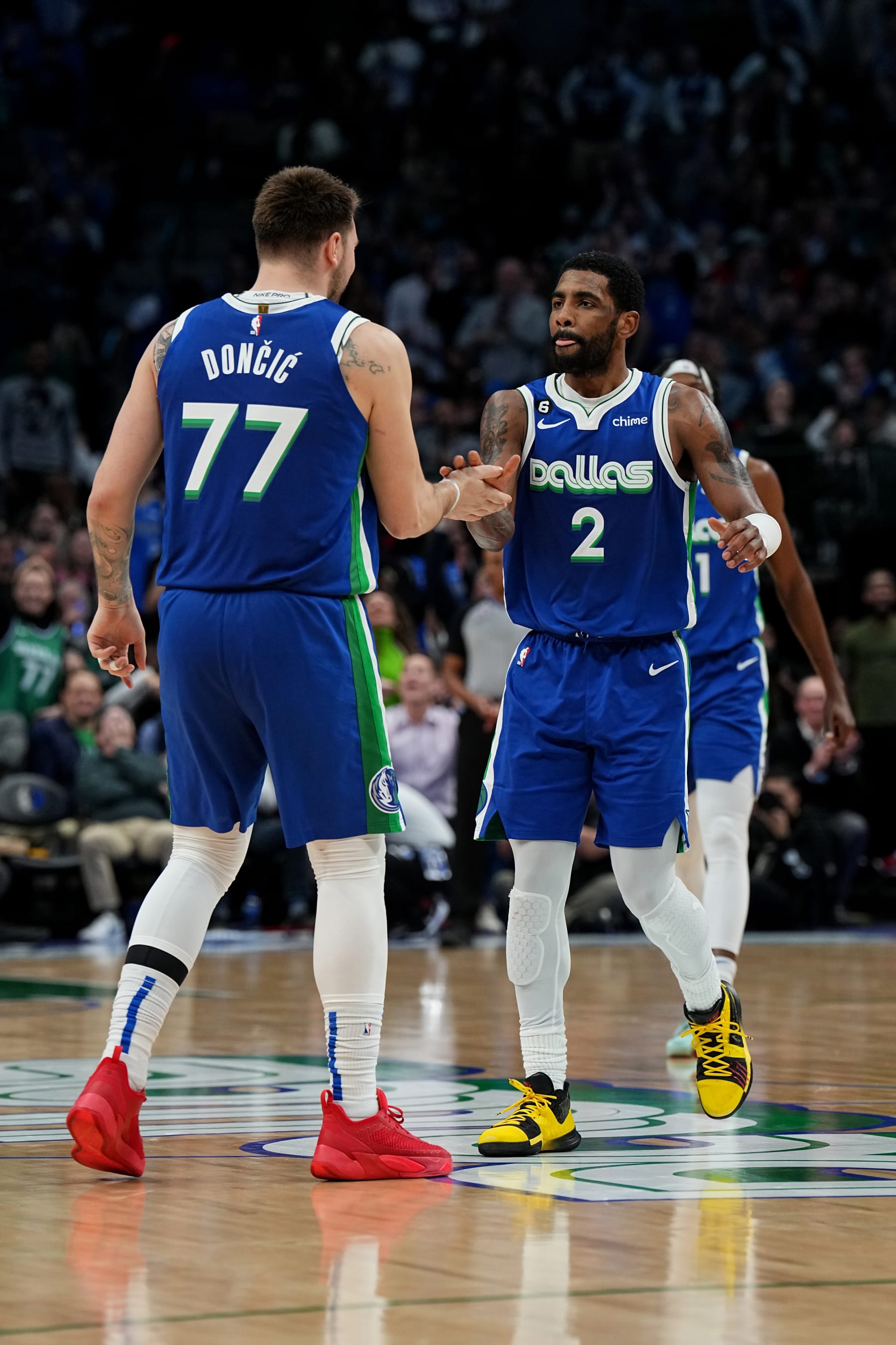 DALLAS, TX - FEBRUARY 13: Luka Doncic #77 of the Dallas Mavericks high fives Kyrie Irving #2 during the game against the Minnesota Timberwolves on February 13, 2023 at the American Airlines Center in Dallas, Texas. NOTE TO USER: User expressly acknowledges and agrees that, by downloading and or using this photograph, User is consenting to the terms and conditions of the Getty Images License Agreement. Mandatory Copyright Notice: Copyright 2023 NBAE (Photo by Glenn James/NBAE via Getty Images)