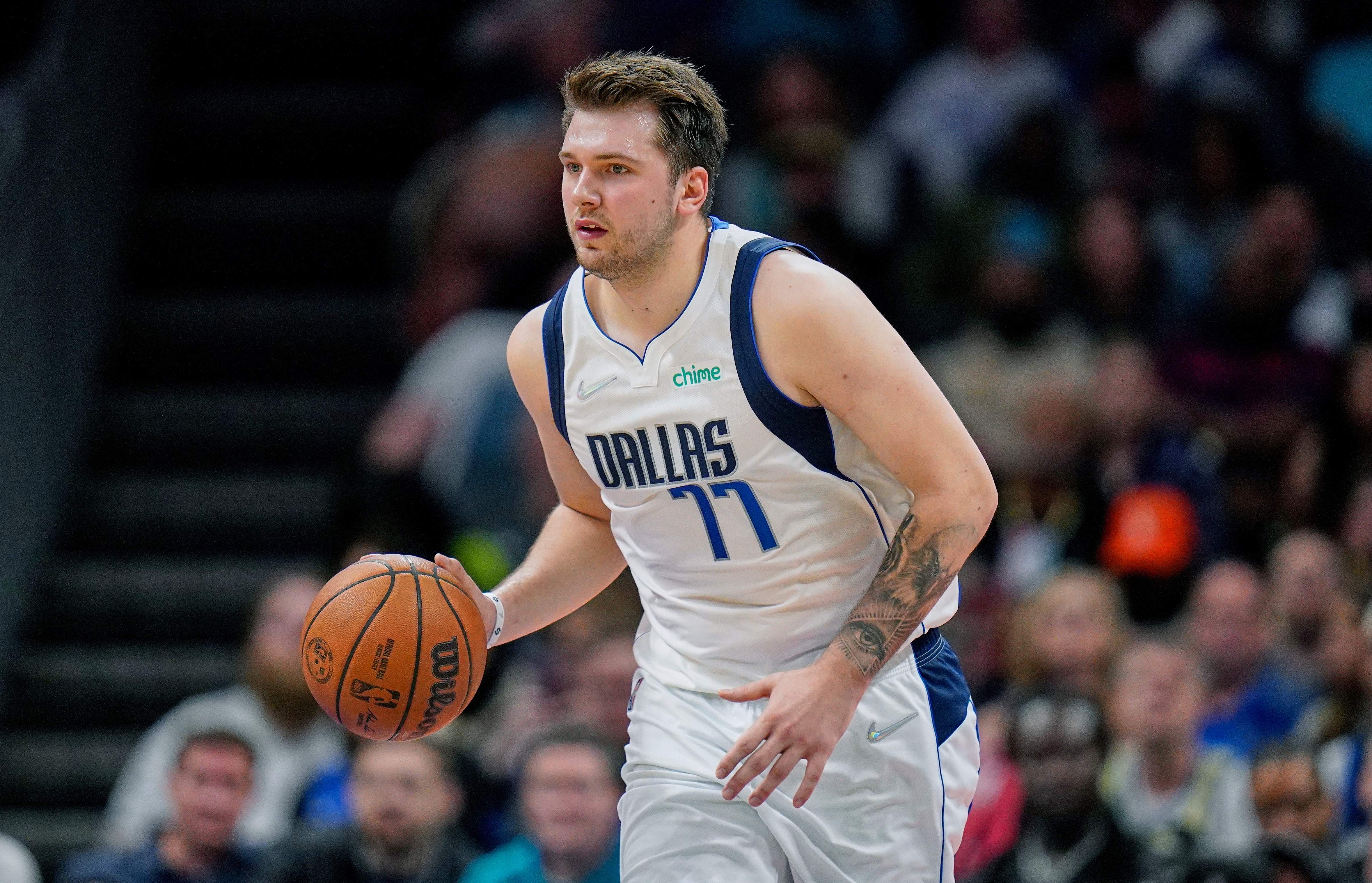 Dallas Mavericks guard Luka Doncic (77) brings the ball upcourt during an NBA basketball game against the Charlotte Hornets on Saturday, March 19, 2022, in Charlotte, N.C. (AP Photo/Rusty Jones)
