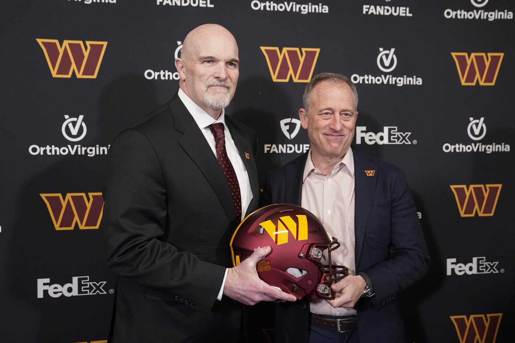 ASHBURN, VIRGINIA - FEBRUARY 05: Head coach Dan Quinn of the Washington Commanders poses for a photo with managing partner Josh Harris following a press conference at OrthoVirginia Training Center at Commanders Park on February 05, 2024 in Ashburn, Virginia. (Photo by Jess Rapfogel/Getty Images)