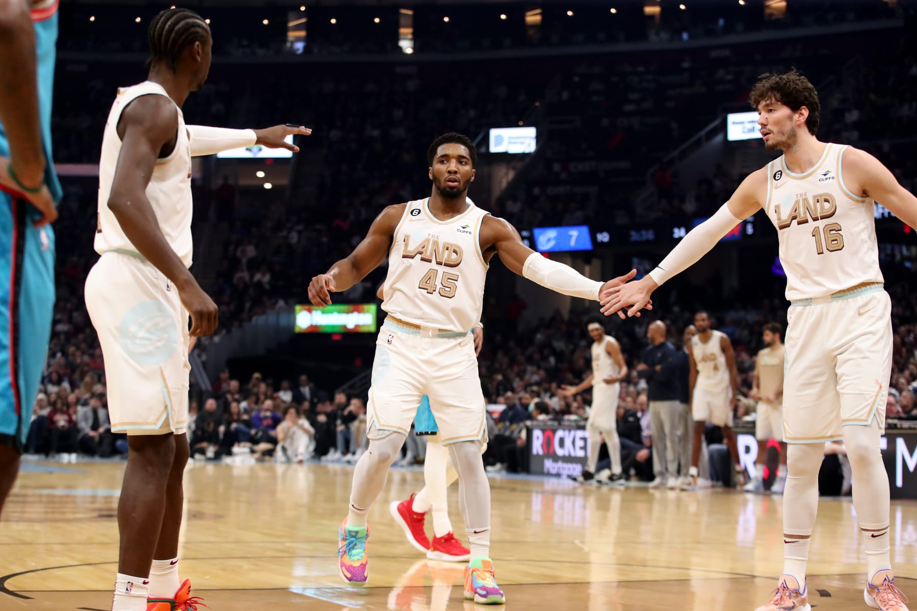 CLEVELAND, OH - JANUARY 4: Cedi Osman #16 and Donovan Mitchell #45 of the Cleveland Cavaliers high fives during the game against the Phoenix Suns  on January 4, 2023 at Rocket Mortgage FieldHouse in Cleveland, Ohio. NOTE TO USER: User expressly acknowledges and agrees that, by downloading and/or using this Photograph, user is consenting to the terms and conditions of the Getty Images License Agreement. Mandatory Copyright Notice: Copyright 2022 NBAE (Photo by  Lauren Bacho/NBAE via Getty Images)