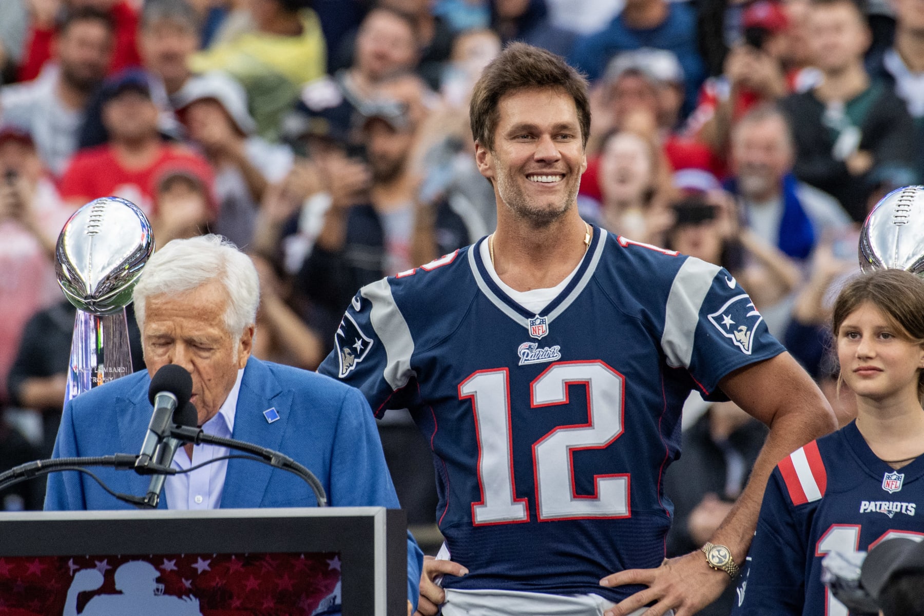 Tom Brady listens to New England Patriots owner Bob Kraft speak during a "Thank You" celebration honoring the former New England Patriots' quarterback during half time of the home opening game for the New England Patriots on September 10, 2023 in Foxborough, Massachusetts. Brady played for 20 seasons with the New England Patriots. (Photo by Joseph Prezioso / AFP) (Photo by JOSEPH PREZIOSO/AFP via Getty Images)