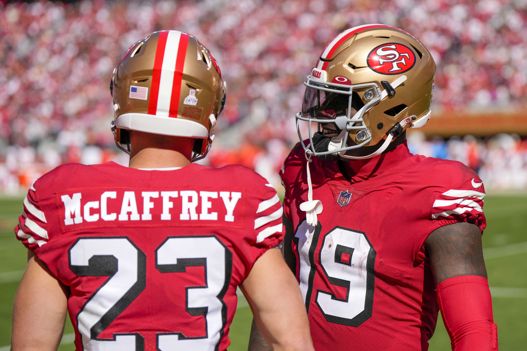 SANTA CLARA, CALIFORNIA - OCTOBER 23: Deebo Samuel #19 talks to Christian McCaffrey #23 of the San Francisco 49ers in the first quarter against the Kansas City Chiefs at Levi's Stadium on October 23, 2022 in Santa Clara, California. (Photo by Thearon W. Henderson/Getty Images)