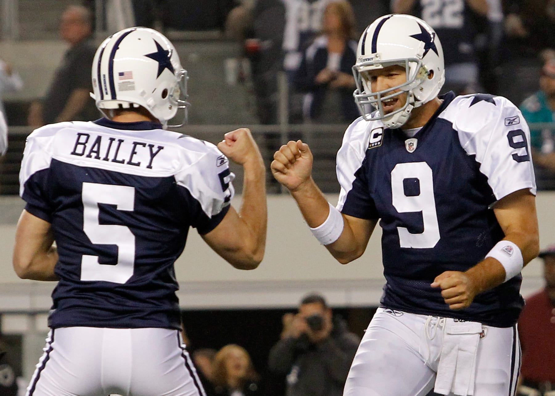 ARLINGTON, TX - NOVEMBER 24:  Tony Romo #9 of the Dallas Cowboys celebrates with  Dan Bailey #5 of the Dallas Cowboys after Bailey kicked the game winning field goal during the Thanksgiving Day game at Cowboys Stadium on November 24, 2011 in Arlington, Texas. The Dallas Cowboys beat the Miami Dolphins 20-19.  (Photo by Tom Pennington/Getty Images)