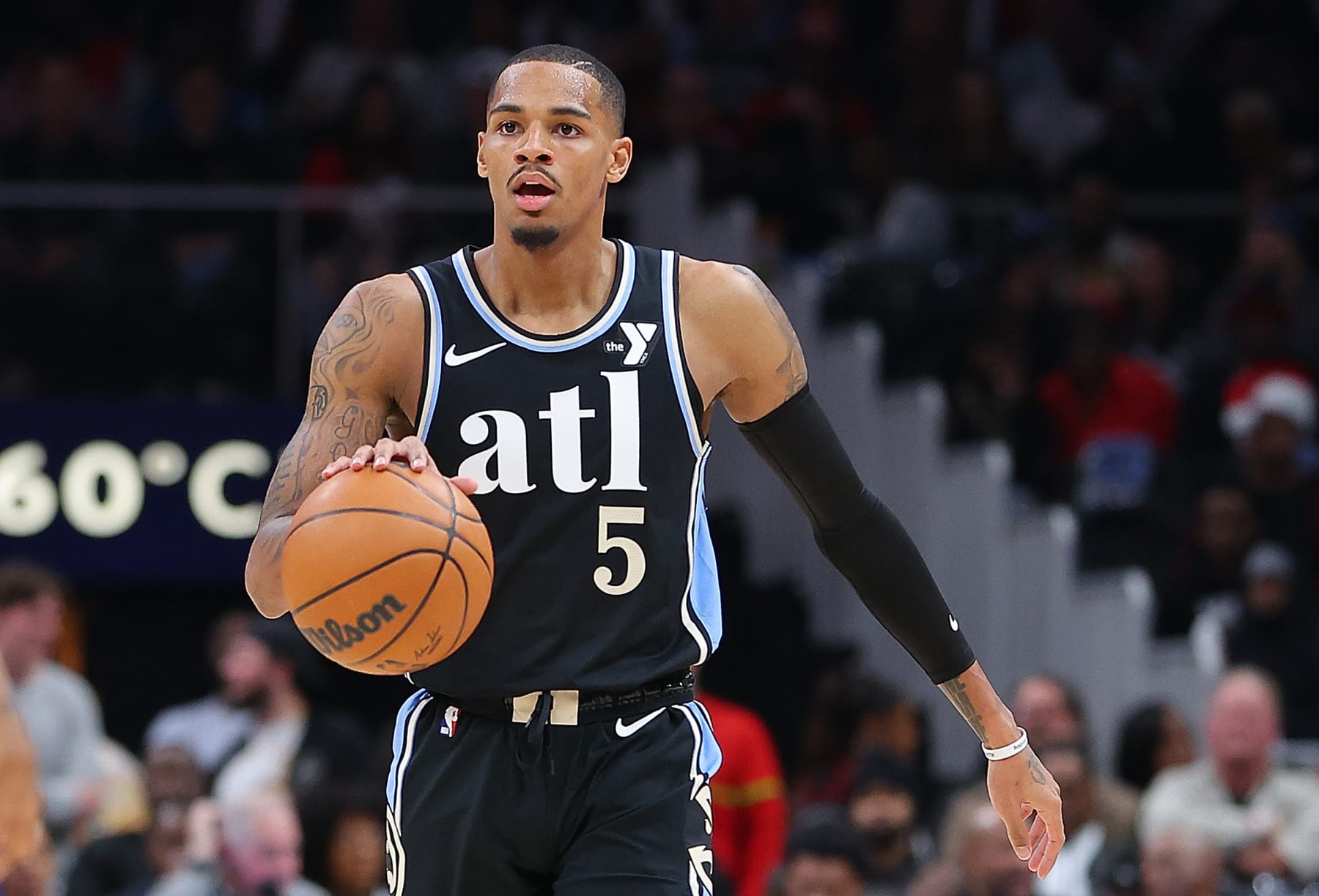 ATLANTA, GEORGIA - DECEMBER 23:  Dejounte Murray #5 of the Atlanta Hawks pushes the ball against the Memphis Grizzlies during the first quarter at State Farm Arena on December 23, 2023 in Atlanta, Georgia.  NOTE TO USER: User expressly acknowledges and agrees that, by downloading and/or using this photograph, user is consenting to the terms and conditions of the Getty Images License Agreement. (Photo by Kevin C. Cox/Getty Images)