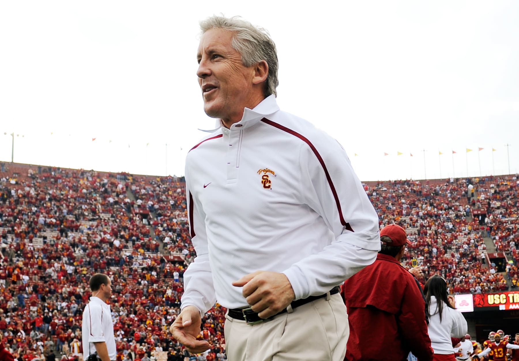 LOS ANGELES, CA - DECEMBER 05:  Coach Pete Carroll of the USC Trojans leads his team to the field prior to the start of the NCAA college football game against Arizona Wildcats at the Los Angeles Coliseum on December 5, 2009 in Los Angeles, California.  (Photo by Kevork Djansezian/Getty Images)