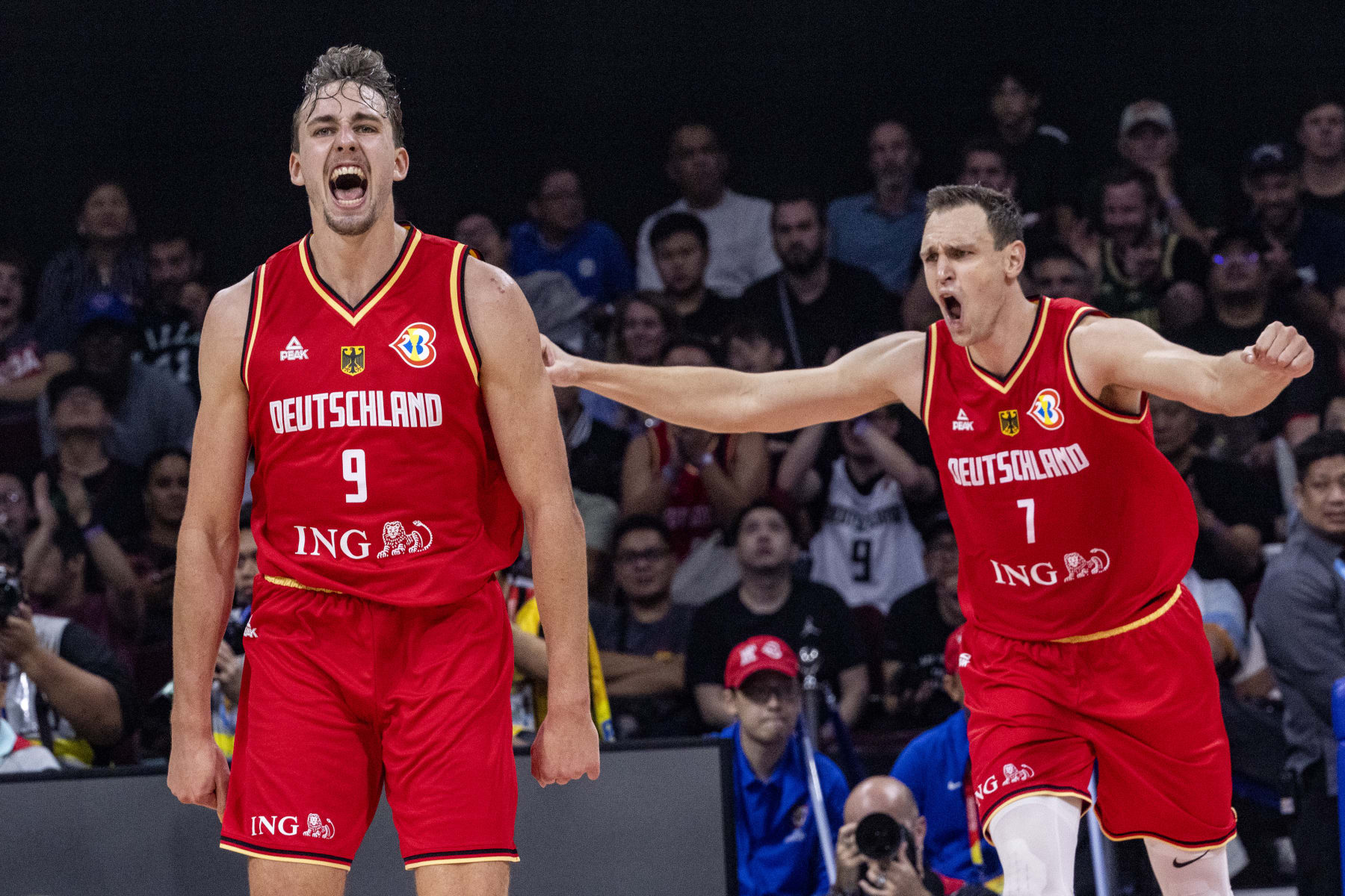 MANILA, PHILIPPINES - SEPTEMBER 08: Franz Wagner #9 and Johannes Voigtmann #7 of Germany celebrate after scoring during the FIBA Basketball World Cup Semi Final game between USA and Germany at Mall of Asia Arena on September 08, 2023 in Manila, Philippines. (Photo by Ezra Acayan/Getty Images)