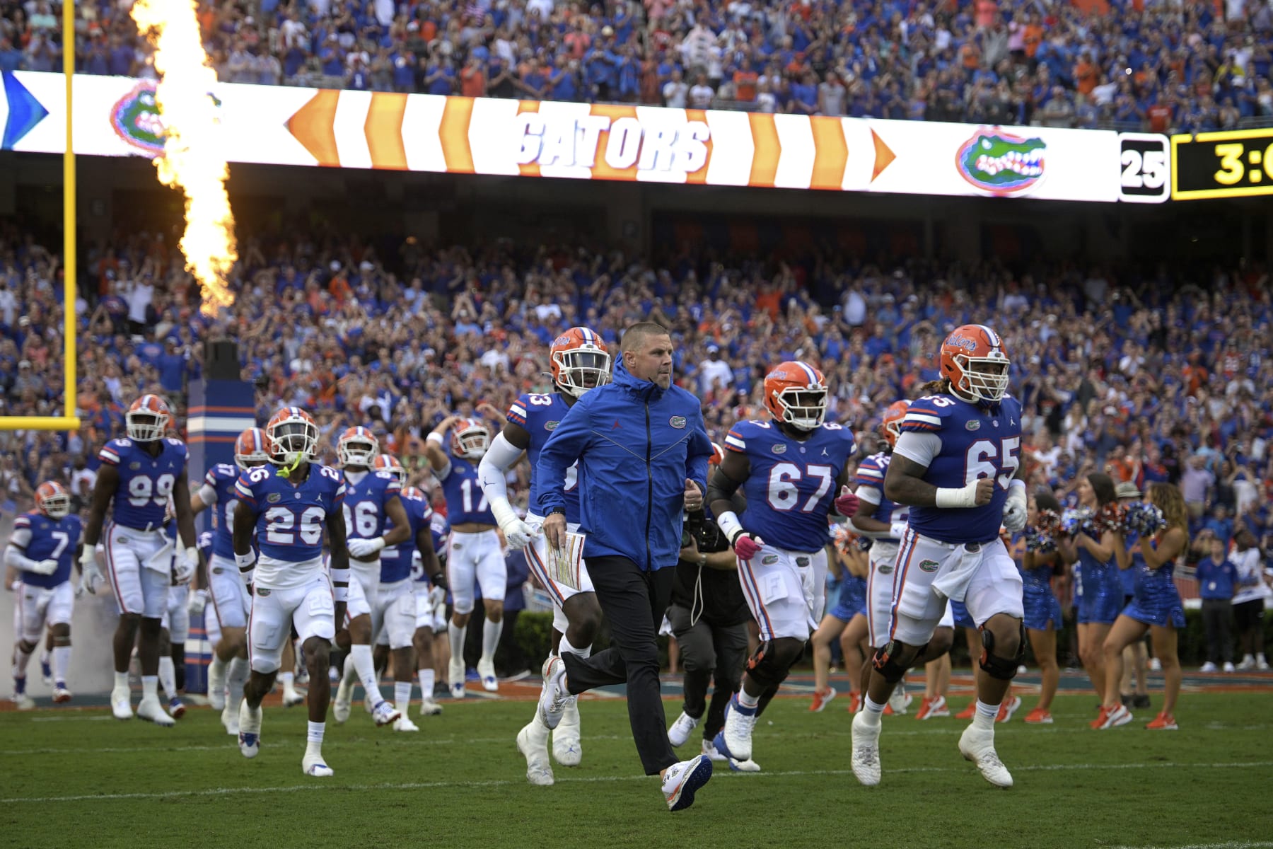 Florida head coach Billy Napier, center, leads the team onto the field before an NCAA college football game against Utah, Saturday, Sept. 3, 2022, in Gainesville, Fla. (AP Photo/Phelan M. Ebenhack)