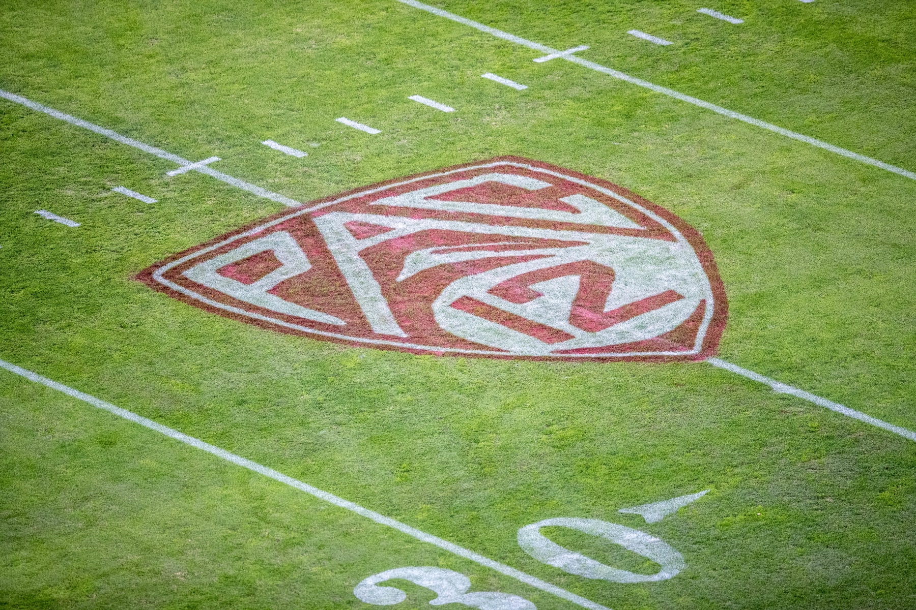 PALO ALTO, CA - NOVEMBER 26:  A close-up view of the Pac 12 logo on the field at Stanford Stadium during an NCAA college football game between the Stanford Cardinal and the BYU Cougars on November 26, 2022 at Stanford Stadium in Palo Alto, California.  (Photo by David Madison/Getty Images)