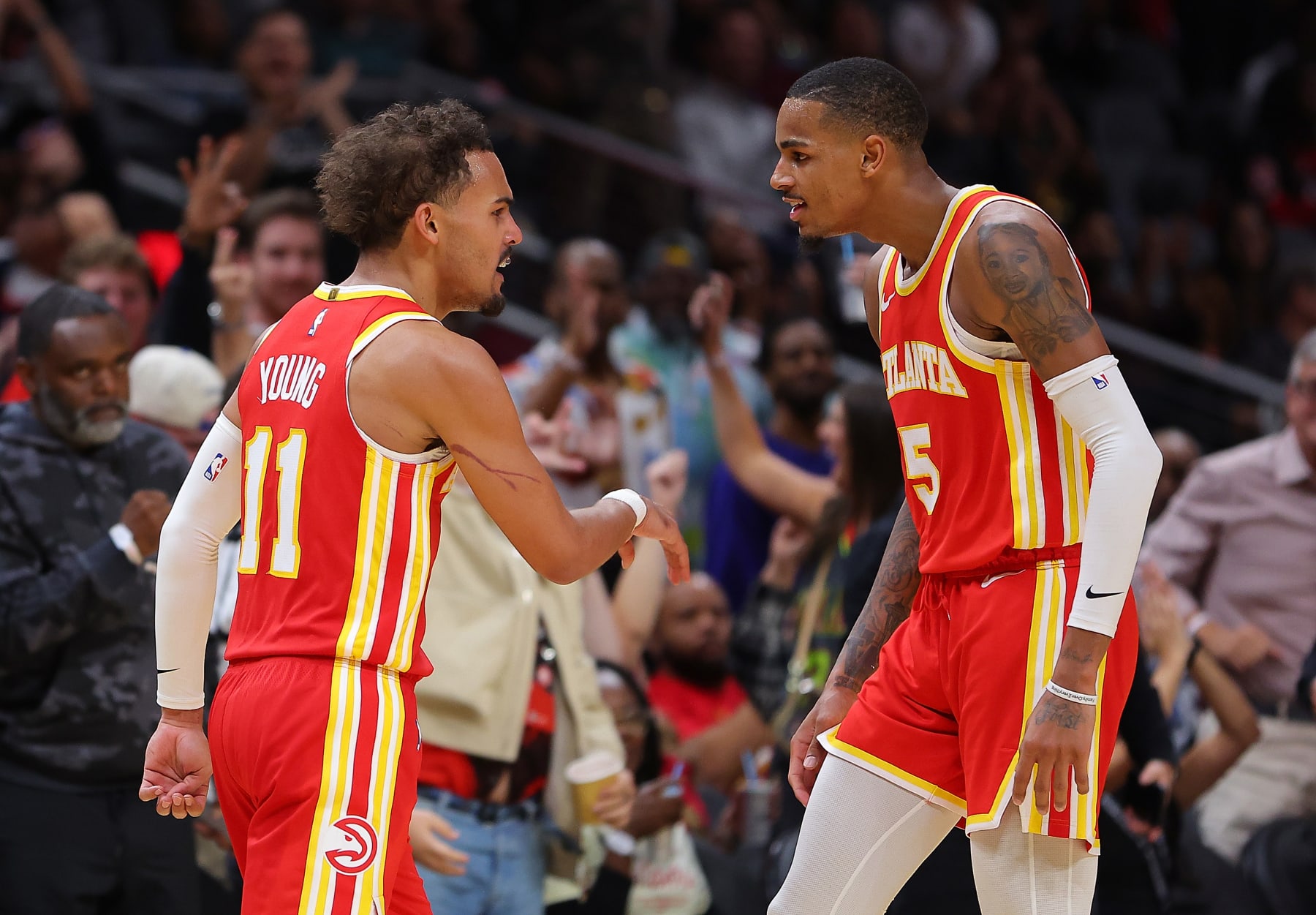ATLANTA, GEORGIA - OCTOBER 30:  Trae Young #11 of the Atlanta Hawks reacts after a three-point basket against the Minnesota Timberwolves with Dejounte Murray #5 during the fourth quarter at State Farm Arena on October 30, 2023 in Atlanta, Georgia.  NOTE TO USER: User expressly acknowledges and agrees that, by downloading and/or using this photograph, user is consenting to the terms and conditions of the Getty Images License Agreement.  (Photo by Kevin C. Cox/Getty Images)