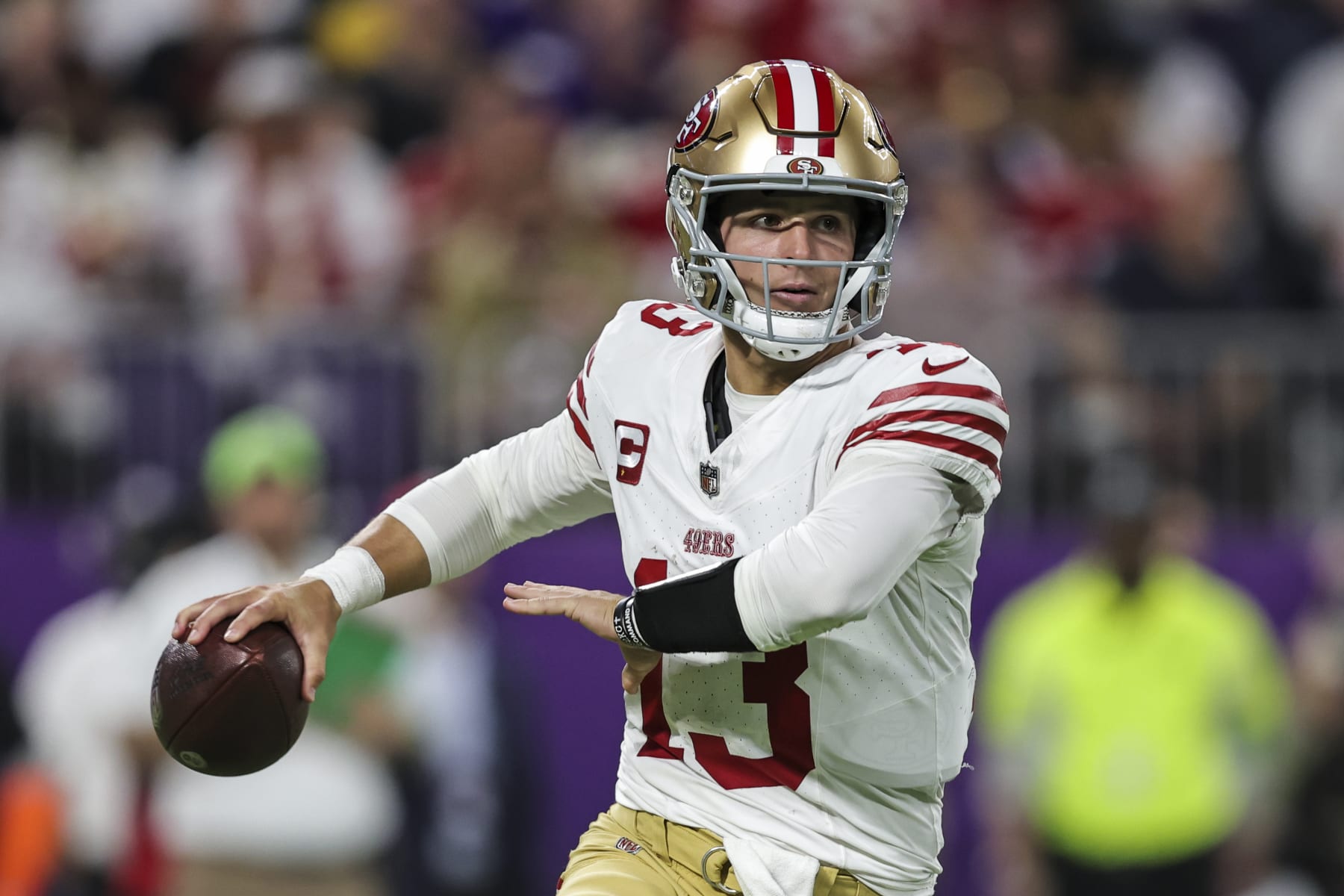 MINNEAPOLIS, MINNESOTA - OCTOBER 23: Brock Purdy #13 of the San Francisco 49ers scrambles and looks to pass during an NFL football game between the Minnesota Vikings and the San Francisco 49ers at U.S. Bank Stadium on October 23, 2023 in Minneapolis, Minnesota. (Photo by Michael Owens/Getty Images)