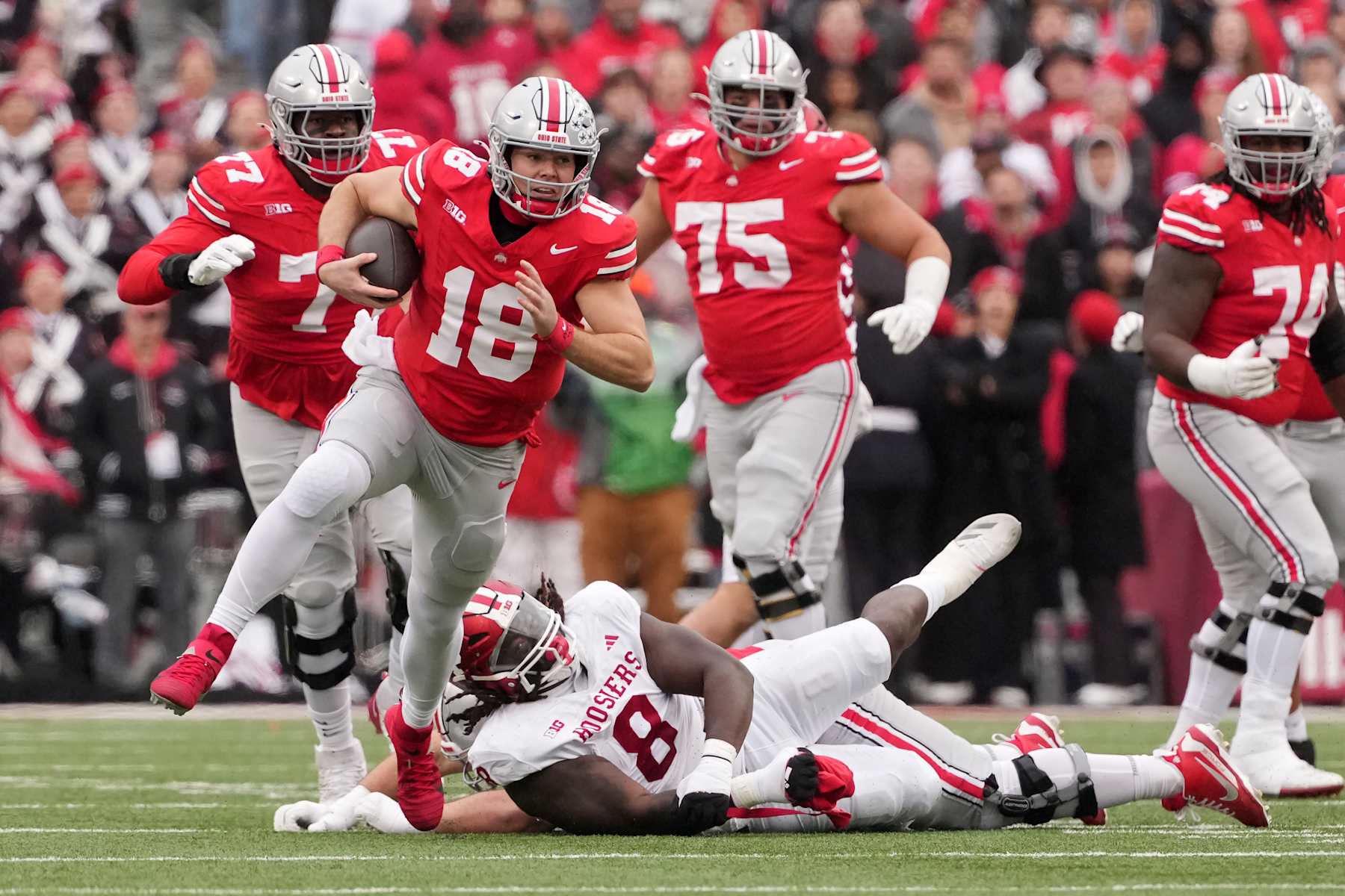 COLUMBUS, OHIO - NOVEMBER 23: Will Howard #18 of the Ohio State Buckeyes runs with the ball in the first quarter against the Indiana Hoosiers at Ohio Stadium on November 23, 2024 in Columbus, Ohio. (Photo by Jason Mowry/Getty Images)