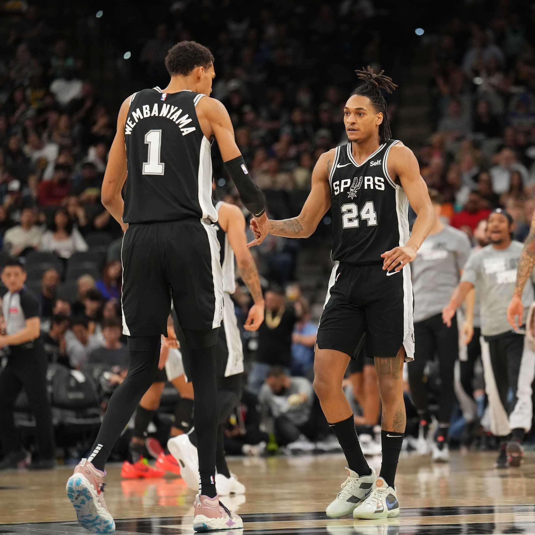SAN ANTONIO, TX - MARCH 11: Victor Wembanyama #1 and Devin Vassell #24 of the San Antonio Spurs high five during the game against the Golden State Warriors on March 11, 2024 at the AT&T Center in San Antonio, Texas. NOTE TO USER: User expressly acknowledges and agrees that, by downloading and or using this photograph, user is consenting to the terms and conditions of the Getty Images License Agreement. Mandatory Copyright Notice: Copyright 2024 NBAE (Photos by Jesse D. Garrabrant/NBAE via Getty Images)