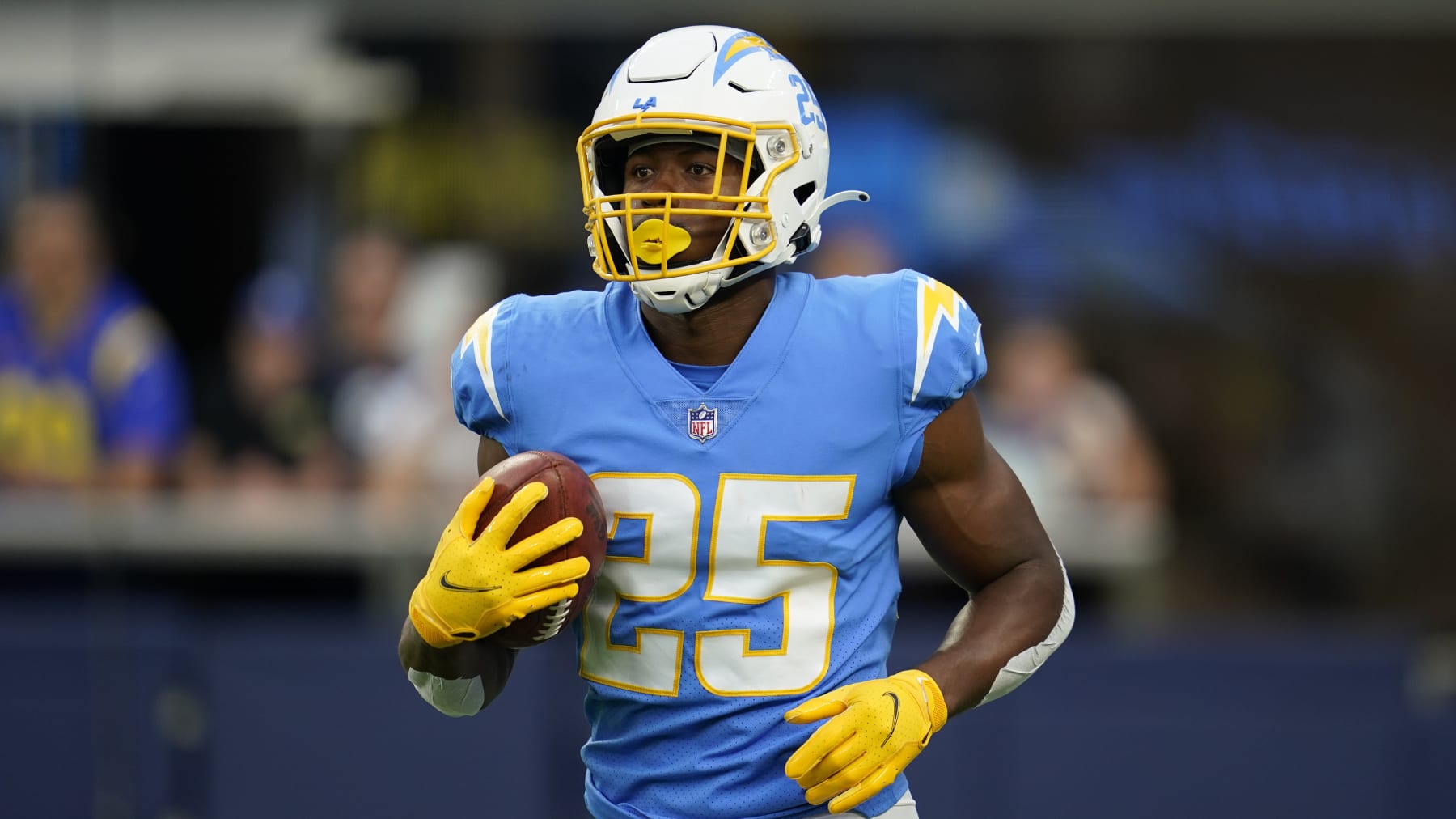 Los Angeles Chargers running back Joshua Kelley (25) warms up before an NFL football game against the Los Angeles Rams Sunday, Aug. 14, 2022, in Inglewood, Calif. (AP Photo/Ashley Landis)