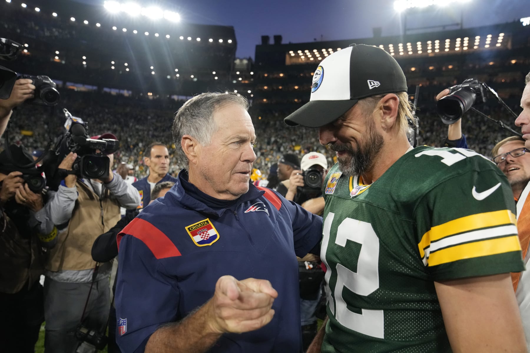 GREEN BAY, WISCONSIN - OCTOBER 02: Head coach Bill Belichick of the New England Patriots and Aaron Rodgers #12 of the Green Bay Packers talk after Green Bay's 27-24 win in overtime at Lambeau Field on October 02, 2022 in Green Bay, Wisconsin. (Photo by Patrick McDermott/Getty Images)