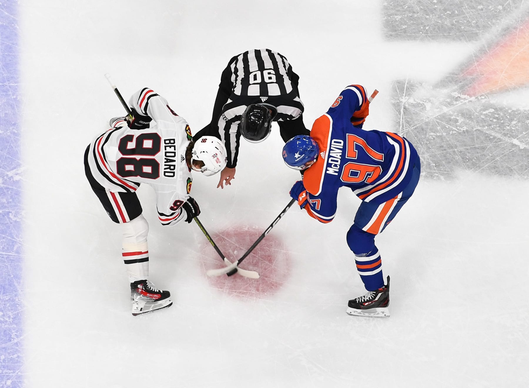 EDMONTON, CANADA - DECEMBER 12: Connor McDavid #97 of the Edmonton Oilers takes a face-off against Connor Bedard #98 of the Chicago Blackhawks during the game at Rogers Place on December 12, 2023, in Edmonton, Alberta, Canada. (Photo by Andy Devlin/NHLI via Getty Images)