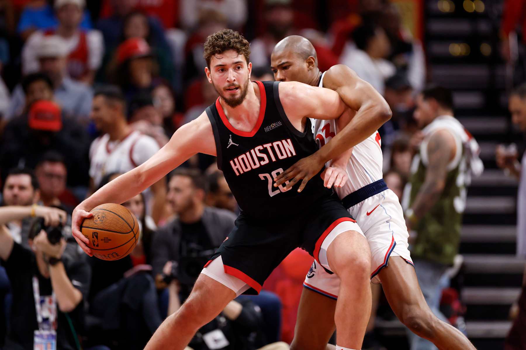 HOUSTON, TEXAS - NOVEMBER 15: Alperen Sengun #28 of the Houston Rockets is defended by Kai Jones #23 of the Los Angeles Clippers in the second half during the Emirates NBA Cup game at Toyota Center on November 15, 2024 in Houston, Texas.  NOTE TO USER: User expressly acknowledges and agrees that, by downloading and/or using this photograph, user is consenting to the terms and conditions of the Getty Images License Agreement.  (Photo by Tim Warner/Getty Images)