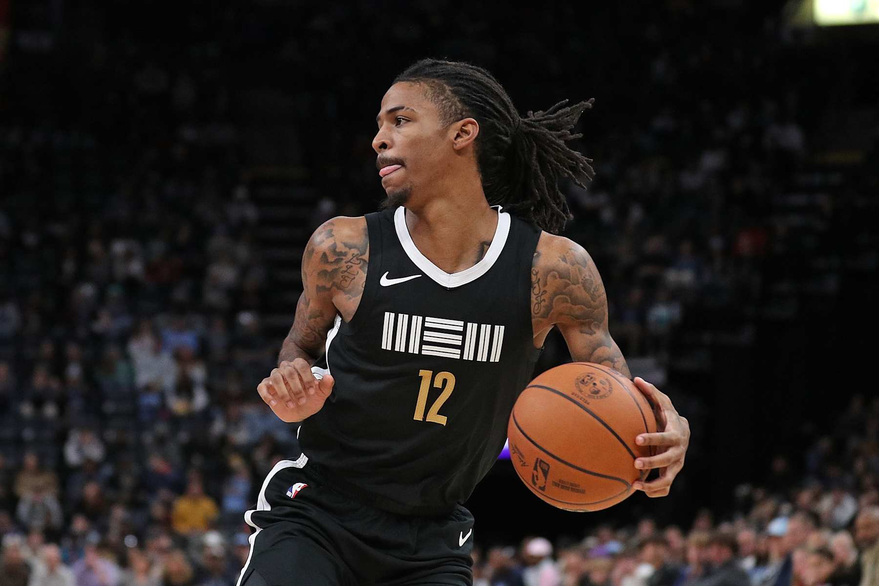 MEMPHIS, TENNESSEE - JANUARY 03: Ja Morant #12 of the Memphis Grizzlies takes a shot during the game against the Toronto Raptors at FedExForum on January 03, 2024 in Memphis, Tennessee. NOTE TO USER: User expressly acknowledges and agrees that, by downloading and or using this photograph, User is consenting to the terms and conditions of the Getty Images License Agreement. (Photo by Justin Ford/Getty Images)