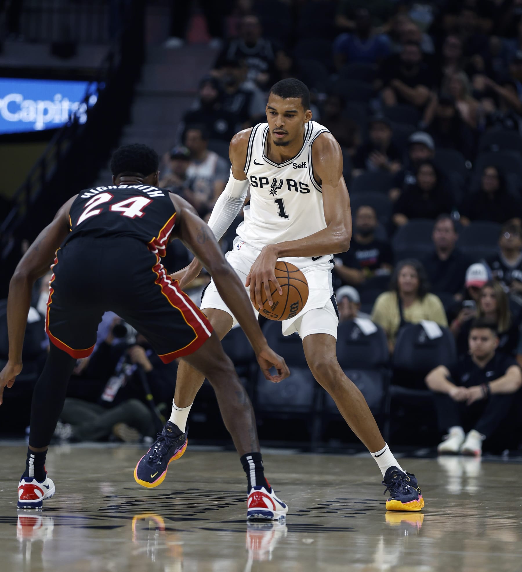 SAN ANTONIO, TX - OCTOBER 13: Victor Wembanyama #1 of the San Antonio Spurs prepares to drive on Haywood Highsmith #24 of the Miami Heat in the first half in a pre-season NBA game at Frost Bank Center on October 13, 2023 in San Antonio, Texas. NOTE TO USER: User expressly acknowledges and agrees that, by downloading and or using this photograph, User is consenting to terms and conditions of the Getty Images License Agreement. (Photo by Ronald Cortes/Getty Images)