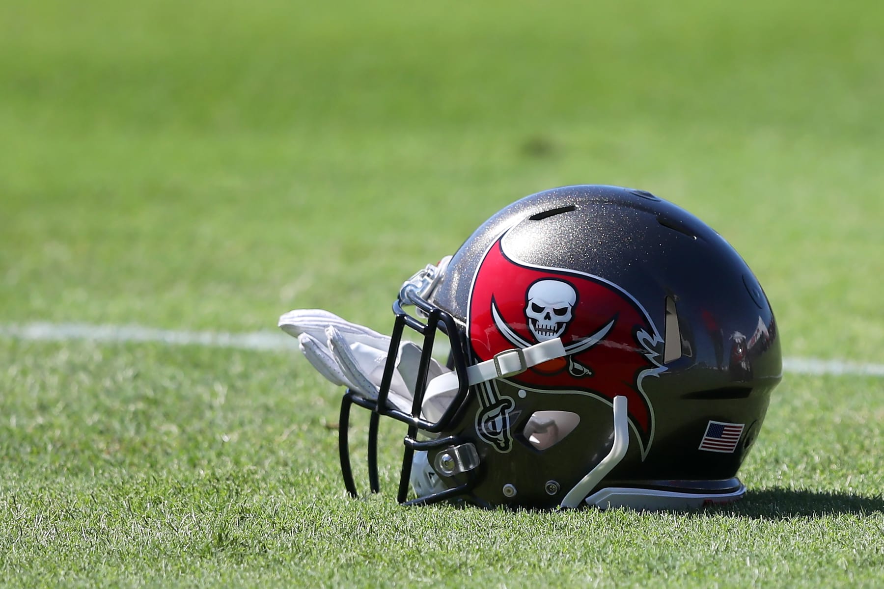 TAMPA, FL - MAY 31: Tampa Bay Buccaneers helmet lies on the ground during the Tampa Bay Buccaneers OTA Offseason Workouts on May 31, 2022 at the AdventHealth Training Center at One Buccaneer Place in Tampa, Florida. (Photo by Cliff Welch/Icon Sportswire via Getty Images)