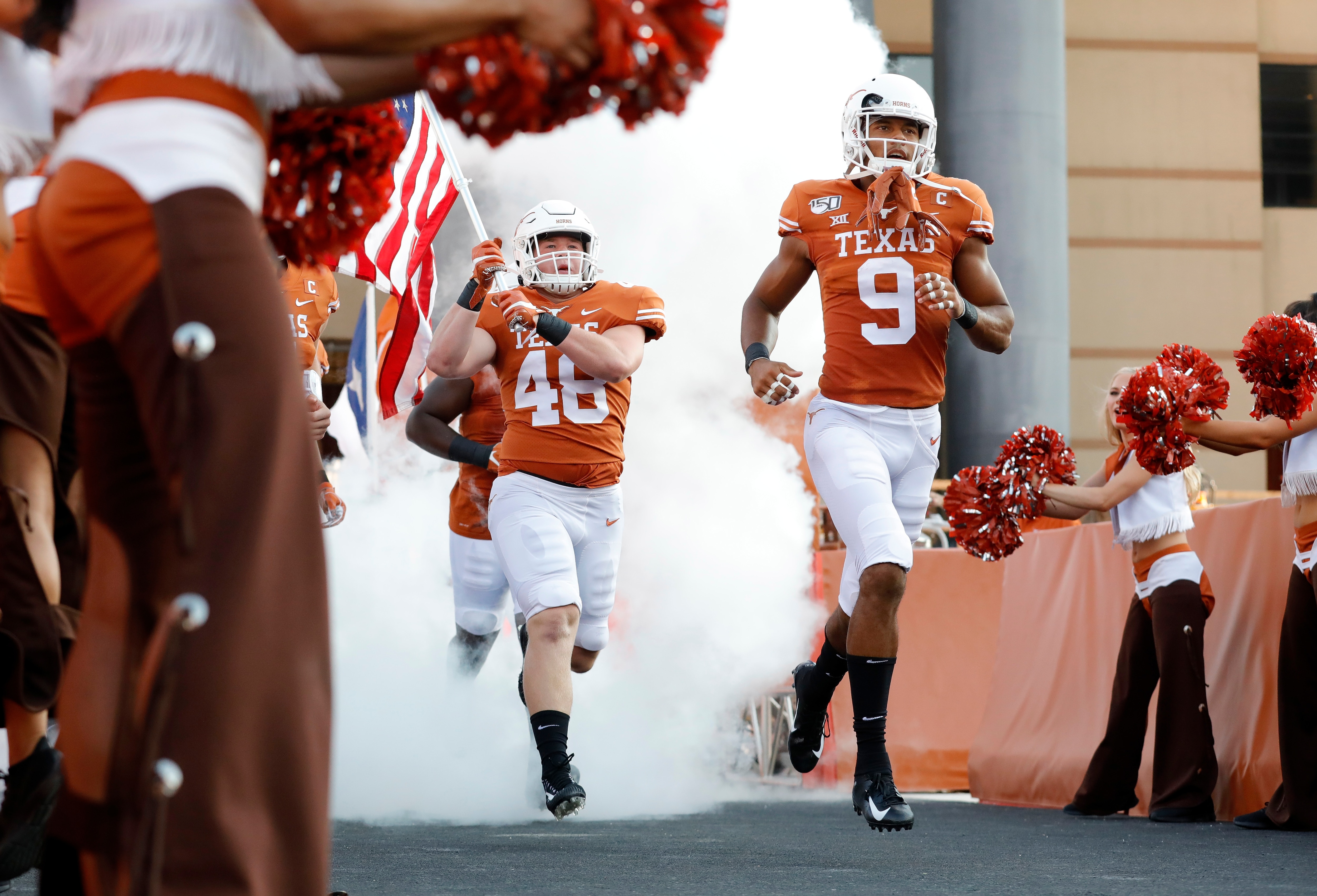 AUSTIN, TX - AUGUST 31:  Collin Johnson #9 of the Texas Longhorns and Jake Ehlinger #48 enter the stadium before the game against the Louisiana Tech Bulldogs at Darrell K Royal-Texas Memorial Stadium on August 31, 2019 in Austin, Texas.  (Photo by Tim Warner/Getty Images)