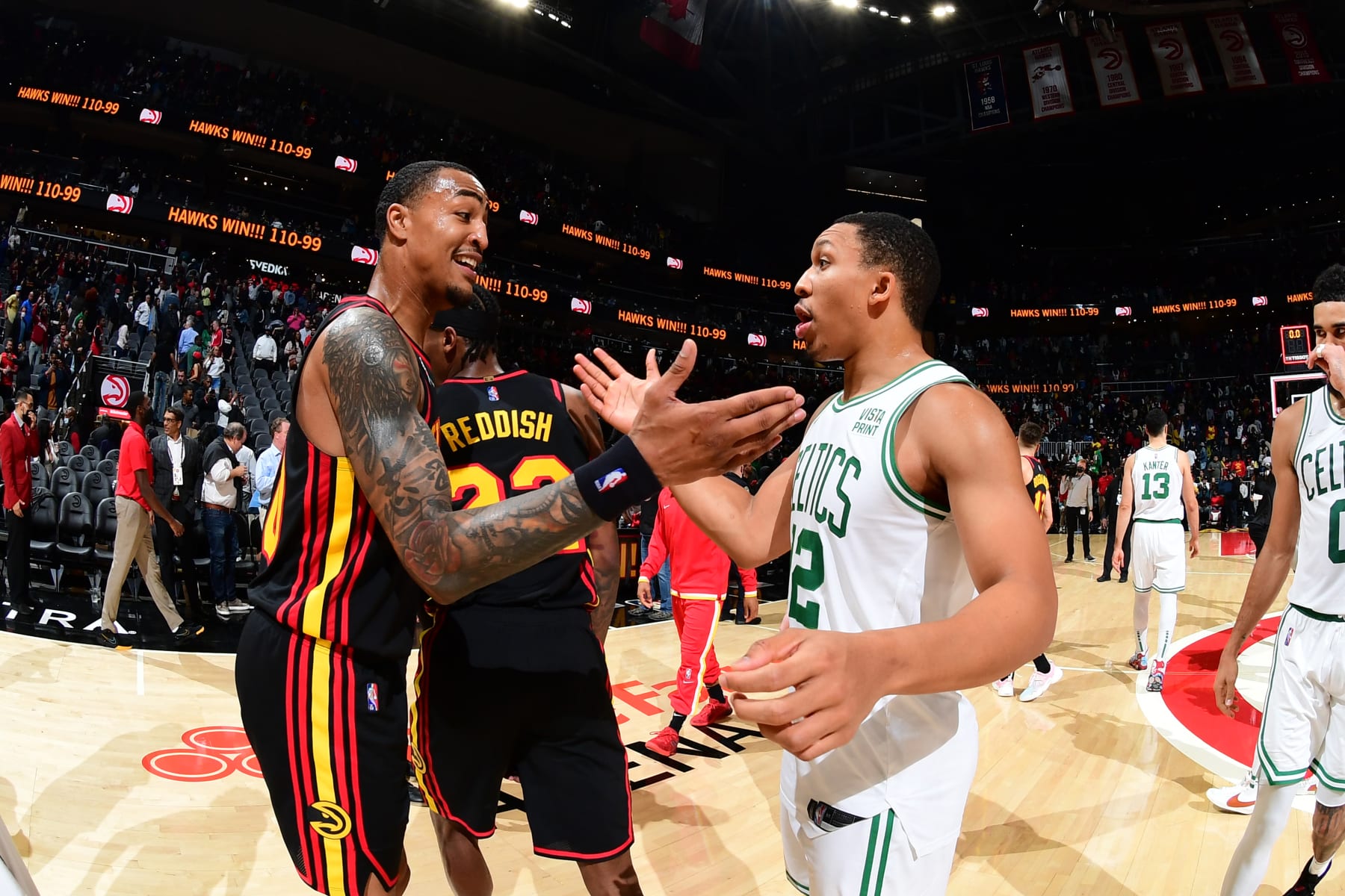 ATLANTA, GA - NOVEMBER 17:  John Collins #20 of the Atlanta Hawks shakes hands with Grant Williams #12 of the Boston Celtics on November 17, 2021 at State Farm Arena in Atlanta, Georgia.  NOTE TO USER: User expressly acknowledges and agrees that, by downloading and/or using this Photograph, user is consenting to the terms and conditions of the Getty Images License Agreement. Mandatory Copyright Notice: Copyright 2021 NBAE (Photo by Scott Cunningham/NBAE via Getty Images)