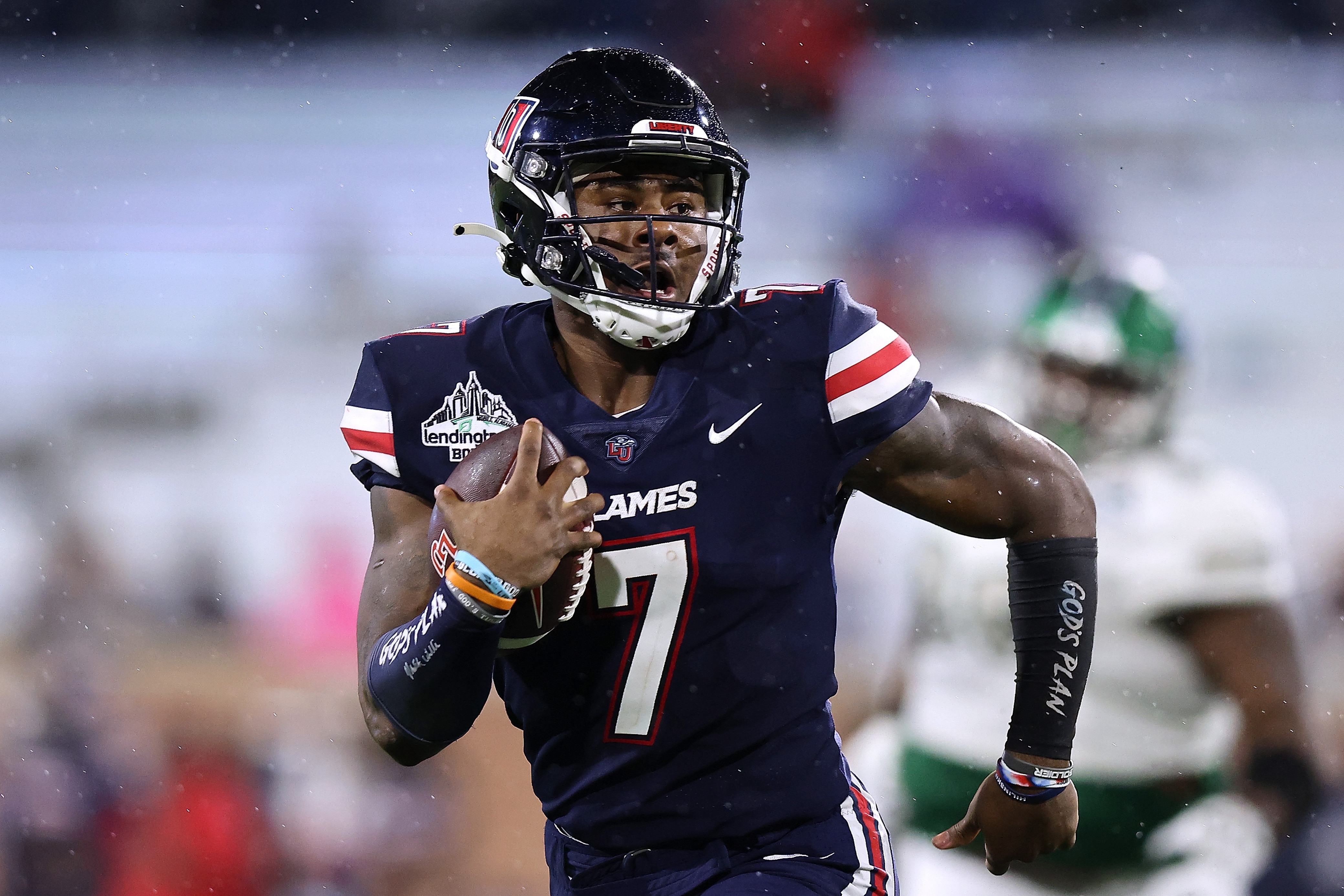 MOBILE, ALABAMA - DECEMBER 18: Malik Willis #7 of the Liberty Flames runs with the ball during the LendingTree Bowl at Hancock Whitney Stadium on December 18, 2021 in Mobile, Alabama. (Photo by Jonathan Bachman/Getty Images)
