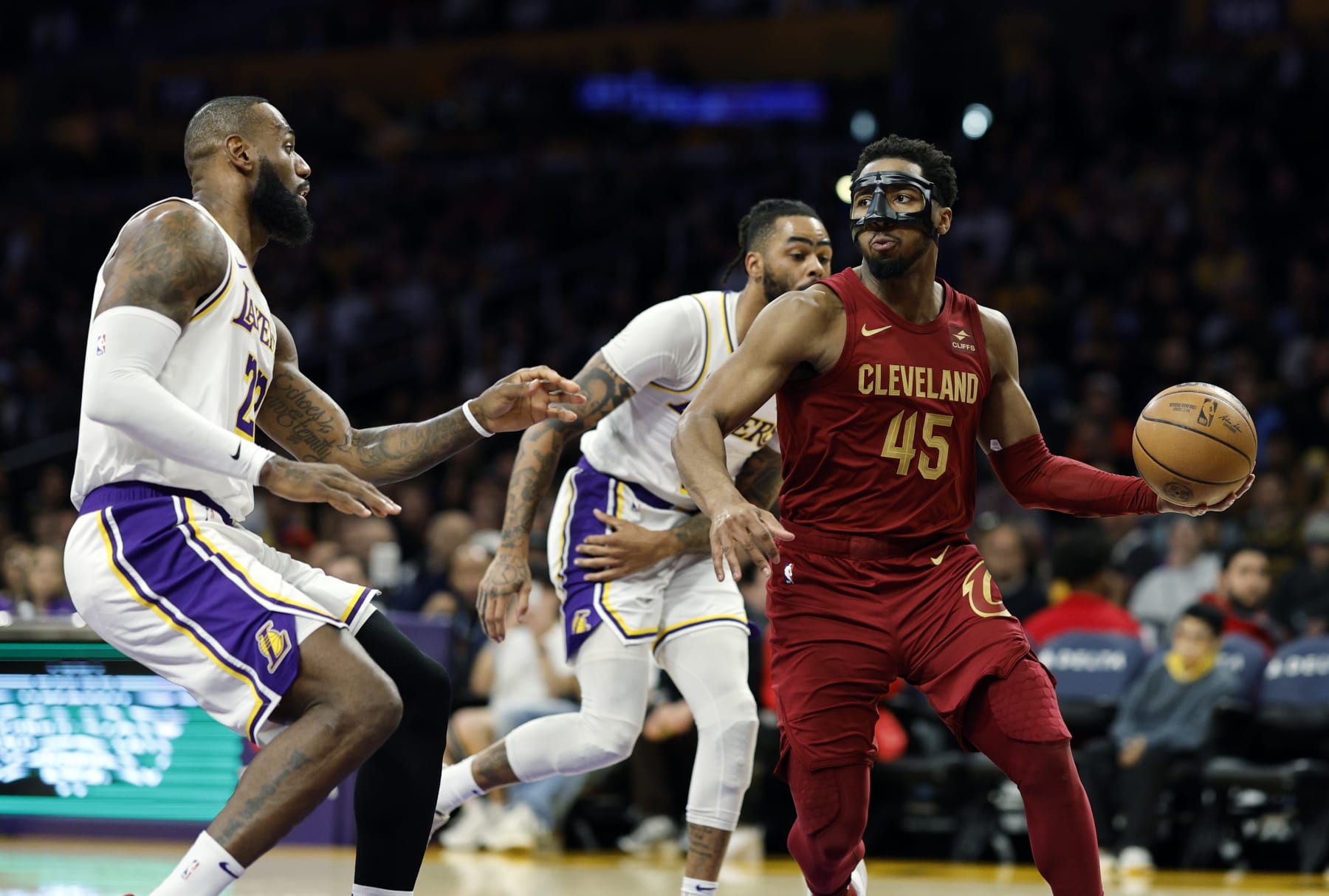 LOS ANGELES, CALIFORNIA - APRIL 6: Donovan Mitchell #45 of the Cleveland Cavaliers looks to pass the ball as he double teamed by LeBron James #23 and D'Angelo Russell #1 of the Los Angeles Lakers during the first half at Crypto.com Arena on April 6, 2024 in Los Angeles, California. NOTE TO USER: User expressly acknowledges and agrees that, by downloading and or using this photograph, User is consenting to the terms and conditions of the Getty Images License Agreement. (Photo by Kevork Djansezian/Getty Images)
