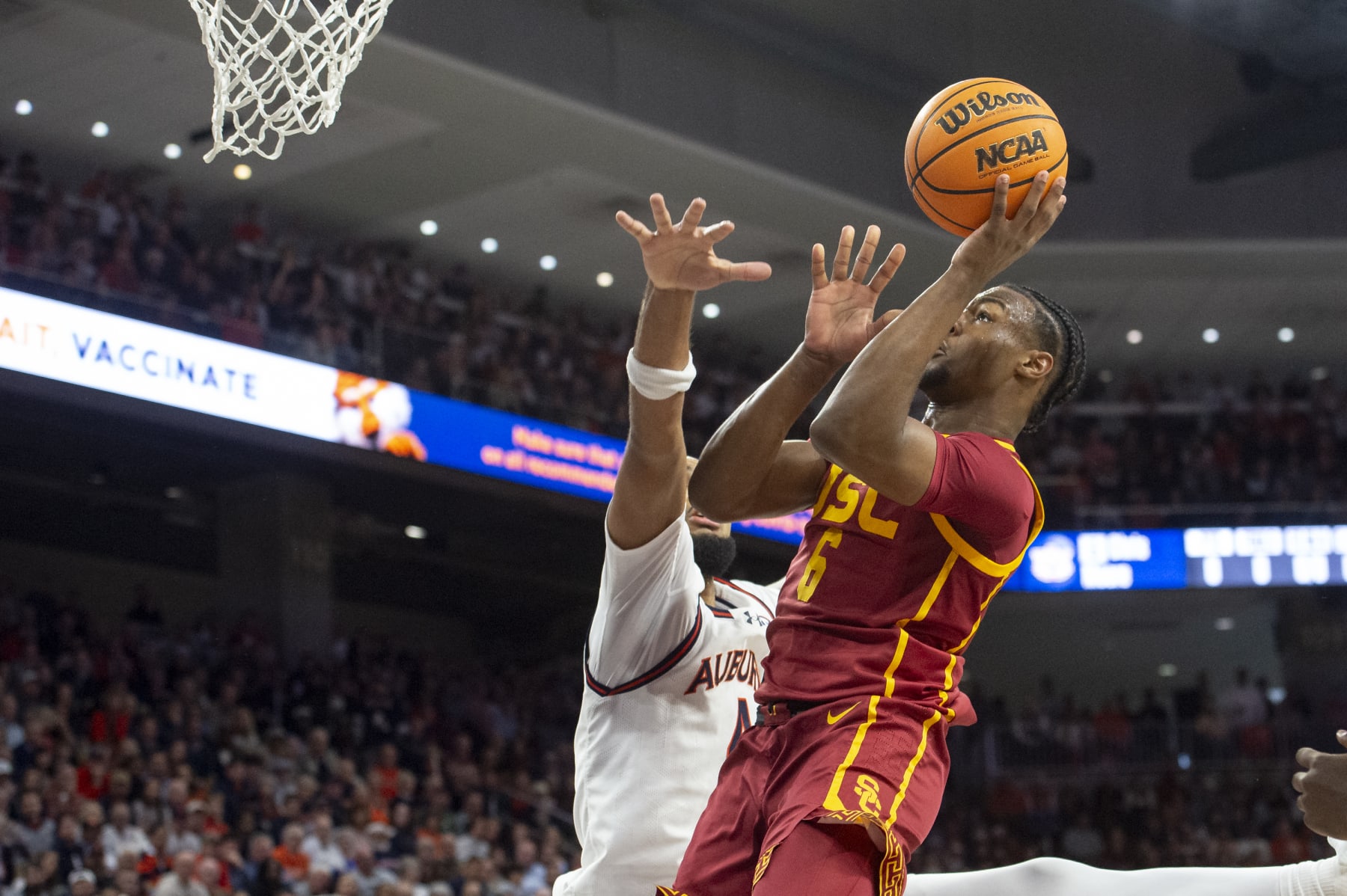 AUBURN, ALABAMA - DECEMBER 17: Bronny James #6 of the USC Trojans looks to attempt a layup in front of Johni Broome #4 of the Auburn Tigers during the first half of play at Neville Arena on December 17, 2023 in Auburn, Alabama. (Photo by Michael Chang/Getty Images)