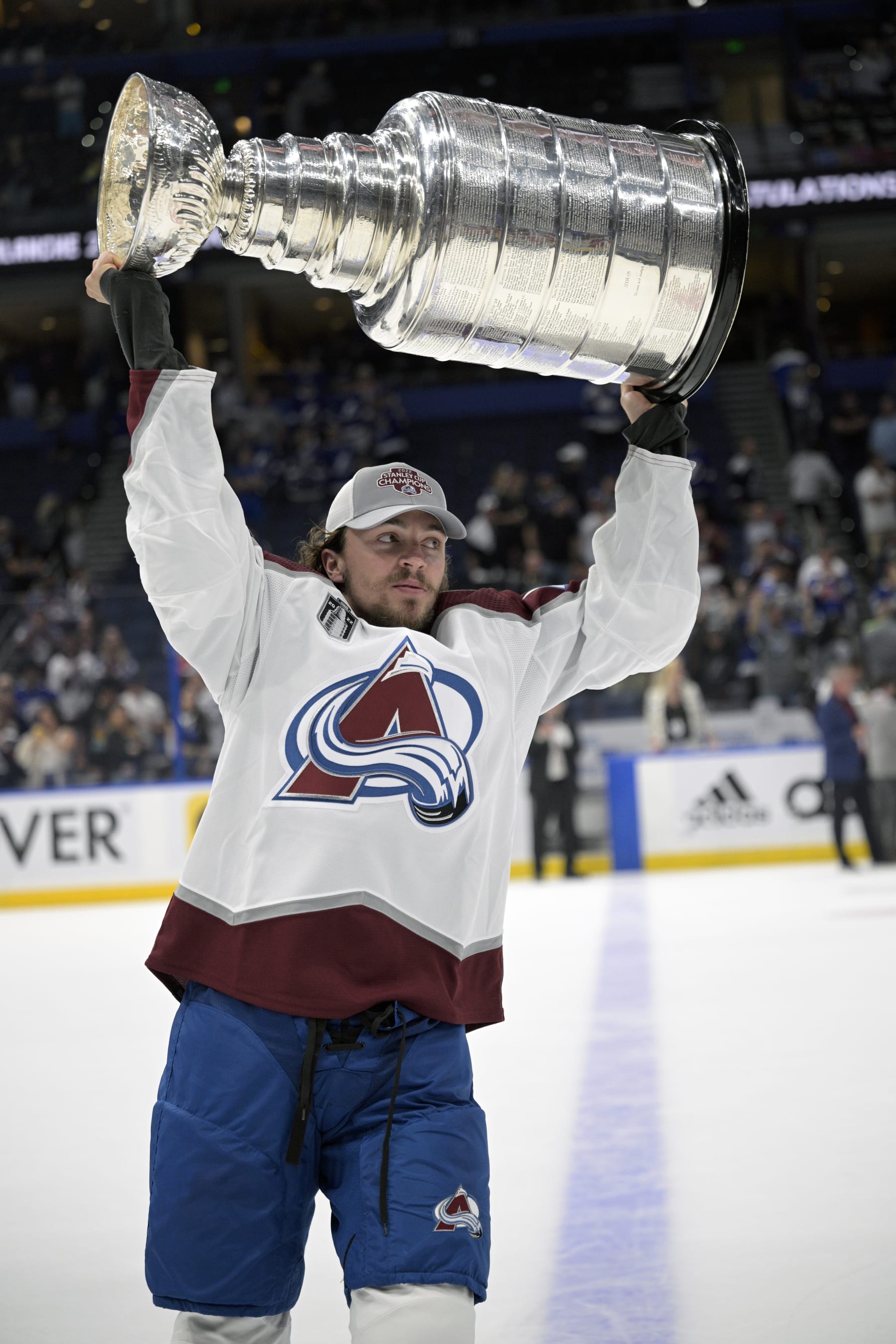 Colorado Avalanche defenseman Samuel Girard (49) lifts the Stanley Cup after the team defeated the Tampa Bay Lightning in Game 6 of the NHL hockey Stanley Cup Finals on Sunday, June 26, 2022, in Tampa, Fla. (AP Photo/Phelan M. Ebenhack)