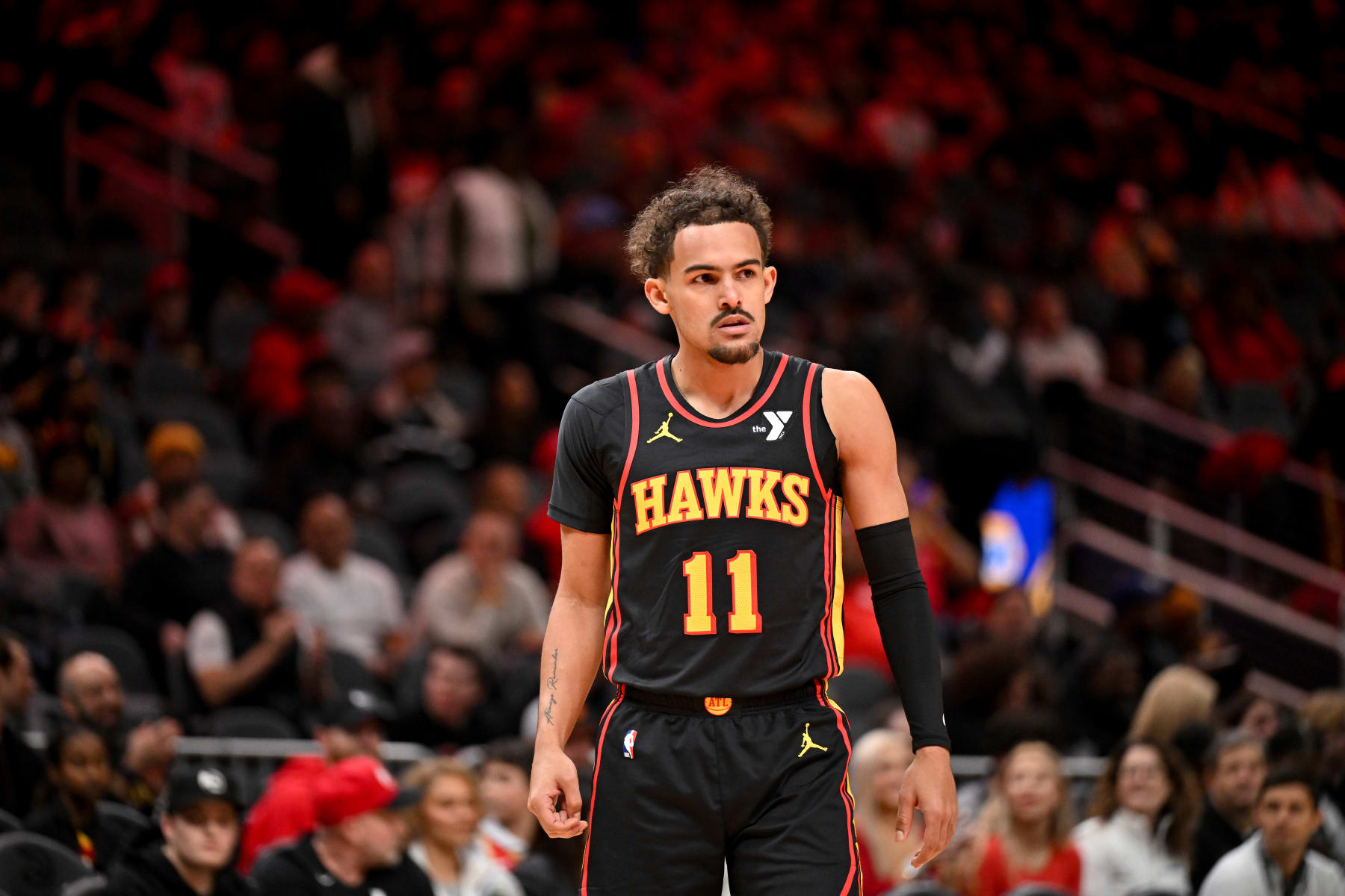 ATLANTA, GEORGIA - JANUARY 12: Trae Young #11 of the Atlanta Hawks looks on during the game against the Indiana Pacers on January 12, 2024 at State Farm Arena in Atlanta, Georgia.  NOTE TO USER: User expressly acknowledges and agrees that, by downloading and or using this photograph, User is consenting to the terms and conditions of the Getty Images License Agreement. (Photo by Paras Griffin/Getty Images)
