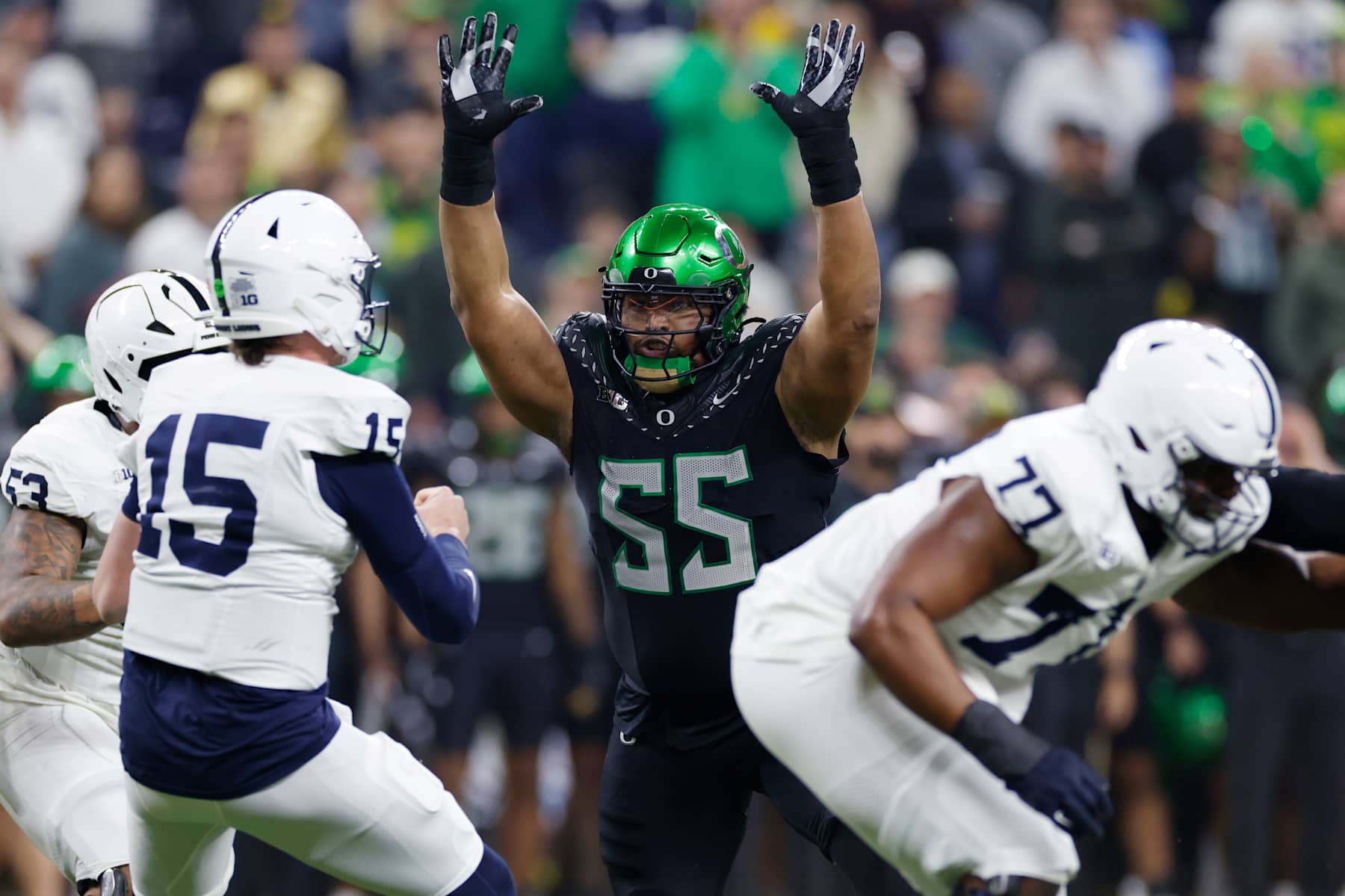 INDIANAPOLIS, IN - DECEMBER 07: Oregon Ducks defensive lineman Derrick Harmon (55) rushes on defense during the Big Ten Championship Game against the Penn State Nittany Lions on December 07, 2024 at Lucas Oil Stadium in Indianapolis, Indiana. (Photo by Joe Robbins/Icon Sportswire via Getty Images)