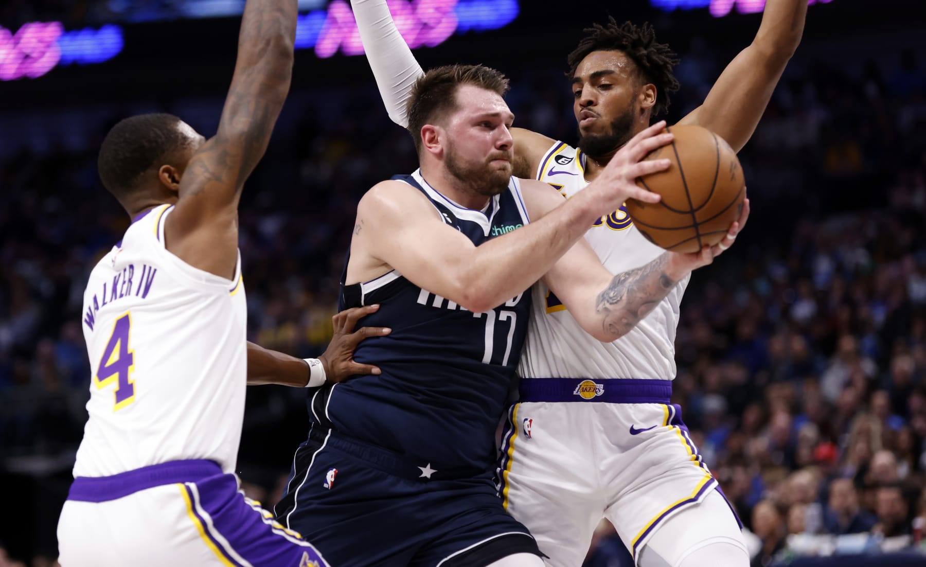 DALLAS, TX - FEBRUARY 26 : Luka Doncic #77 of the Dallas Mavericks goes to the basket as Lonnie Walker IV #4 and Troy Brown Jr. #7 of the Los Angeles Lakers defend in the first half of the game at American Airlines Center on February 26, 2023 in Dallas, Texas. NOTE TO USER: User expressly acknowledges and agrees that, by downloading and or using this photograph, User is consenting to the terms and conditions of the Getty Images License Agreement. (Photo by Ron Jenkins/Getty Images)