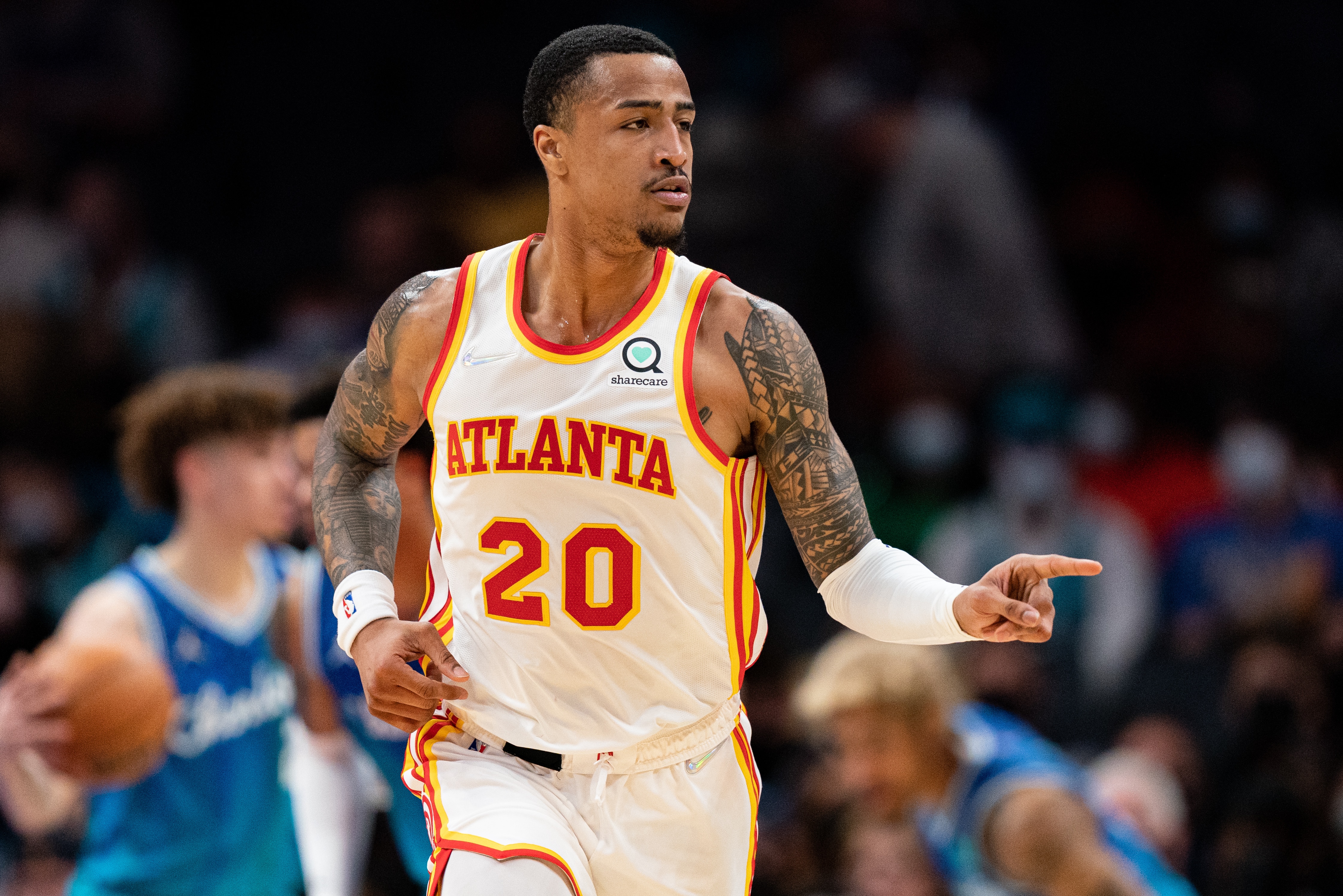CHARLOTTE, NORTH CAROLINA - JANUARY 23: John Collins #20 of the Atlanta Hawks reacts after making a shot against the Charlotte Hornets in the first quarter during their game at Spectrum Center on January 23, 2022 in Charlotte, North Carolina. NOTE TO USER: User expressly acknowledges and agrees that, by downloading and or using this photograph, User is consenting to the terms and conditions of the Getty Images License Agreement. (Photo by Jacob Kupferman/Getty Images)