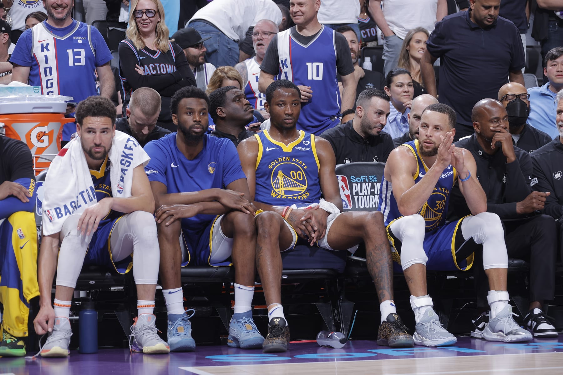 SACRAMENTO, CA - APRIL 16: Klay Thompson #11, Andrew Wiggins #22, Jonathan Kuminga #00, and Stephen Curry #30 of the Golden State Warriors look on from the bench during the game against the Sacramento Kings during the 2024 Play-In Tournament on April 16, 2024 at Golden 1 Center in Sacramento, California. NOTE TO USER: User expressly acknowledges and agrees that, by downloading and or using this photograph, User is consenting to the terms and conditions of the Getty Images Agreement. Mandatory Copyright Notice: Copyright 2024 NBAE (Photo by Rocky Widner/NBAE via Getty Images)
