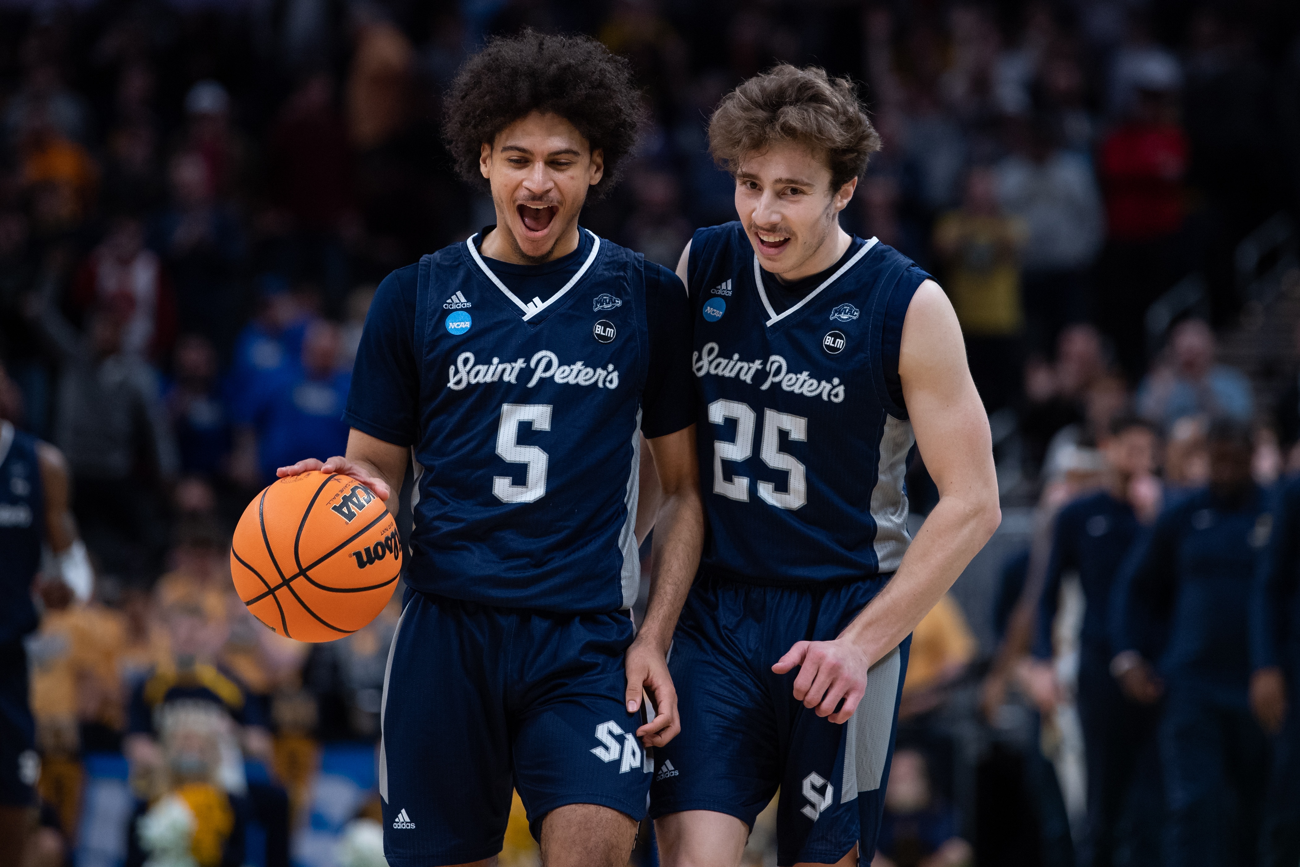 INDIANAPOLIS, IN - MARCH 19: Saint Peter's Peacocks guard Doug Edert (25) and Saint Peter's Peacocks guard Daryl Banks III (5) celebrate on the court during the NCAA Division I Mens Basketball Championship Round 2 game between the Murray State Racers and Saint Peters Peacocks on March 19, 2022, at Gainbridge Fieldhouse in Indianapolis, IN. (Photo by Zach Bolinger/Icon Sportswire via Getty Images)
