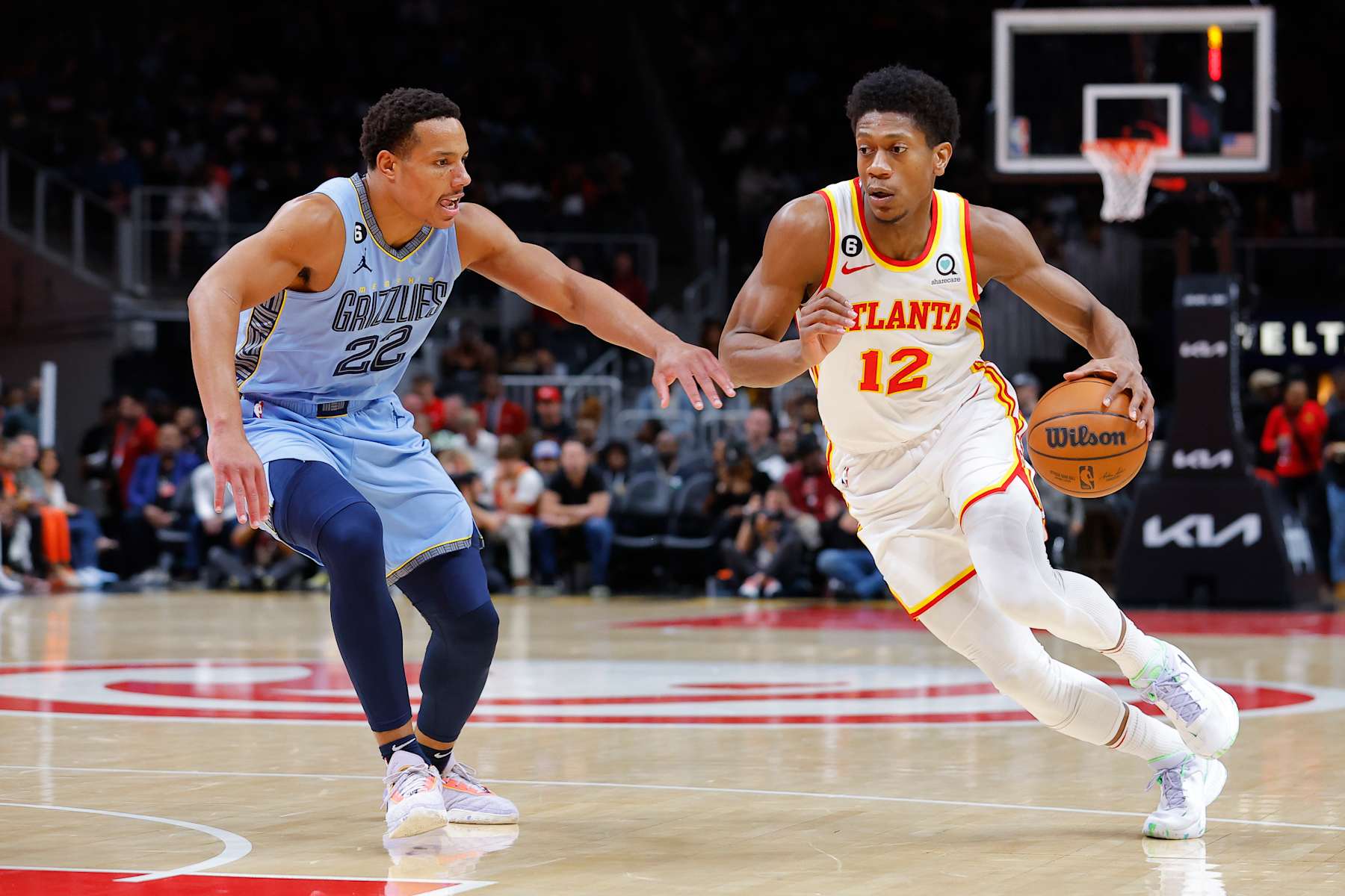ATLANTA, GA - MARCH 26: De'Andre Hunter #12 of the Atlanta Hawks drives against Desmond Bane #22 of the Memphis Grizzlies during the first half at State Farm Arena on March 26, 2023 in Atlanta, Georgia. NOTE TO USER: User expressly acknowledges and agrees that, by downloading and or using this photograph, User is consenting to the terms and conditions of the Getty Images License Agreement. (Photo by Todd Kirkland/Getty Images)