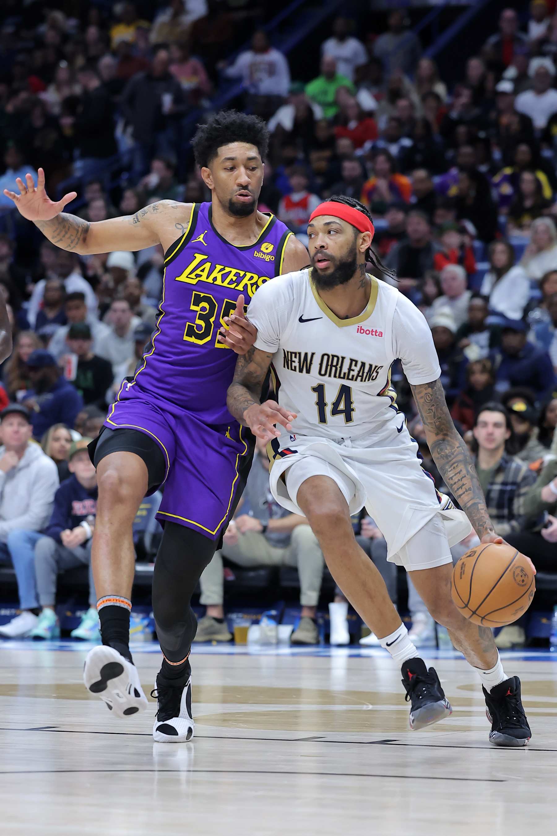 NEW ORLEANS, LOUISIANA - DECEMBER 31: Brandon Ingram #14 of the New Orleans Pelicans drives against Christian Wood #35 of the Los Angeles Lakers during the second half at the Smoothie King Center on December 31, 2023 in New Orleans, Louisiana. NOTE TO USER: User expressly acknowledges and agrees that, by downloading and or using this Photograph, user is consenting to the terms and conditions of the Getty Images License Agreement. (Photo by Jonathan Bachman/Getty Images)