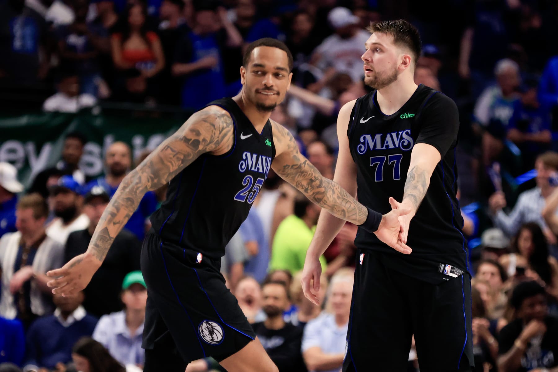 DALLAS, TEXAS - MAY 03: Luka Doncic #77 of the Dallas Mavericks high fives P.J. Washington #25 during the fourth quarter against the Los Angeles Clippers in Game Six of the Western Conference First Round Playoffs at American Airlines Center on May 03, 2024 in Dallas, Texas. NOTE TO USER: User expressly acknowledges and agrees that, by downloading and/or using this Photograph, user is consenting to the terms and conditions of the Getty Images License Agreement.  (Photo by Ron Jenkins/Getty Images)