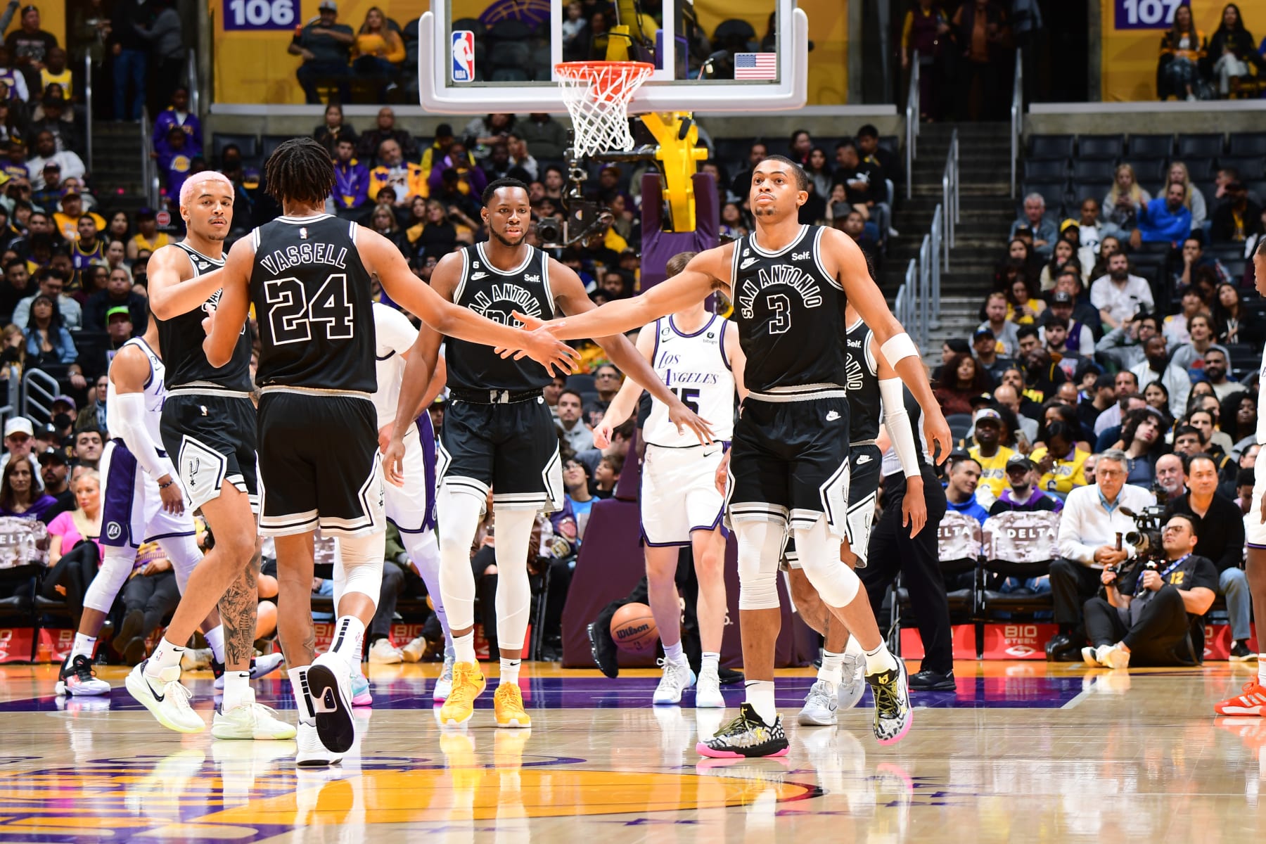 LOS ANGELES, CA - NOVEMBER 20: Devin Vassell #24 and Keldon Johnson #3 of the San Antonio Spurs high five during the game against the Los Angeles Lakers on November 20, 2022 at Crypto.Com Arena in Los Angeles, California. NOTE TO USER: User expressly acknowledges and agrees that, by downloading and/or using this Photograph, user is consenting to the terms and conditions of the Getty Images License Agreement. Mandatory Copyright Notice: Copyright 2022 NBAE (Photo by Adam Pantozzi/NBAE via Getty Images)