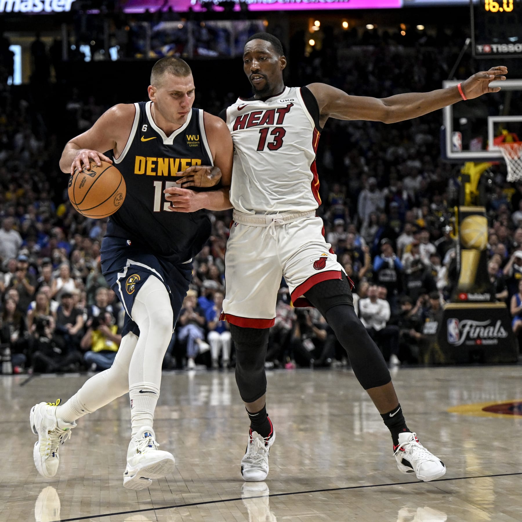 DENVER, CO - JUNE 4: Nikola Jokic (15) of the Denver Nuggets drives on Bam Adebayo (13) of the Miami Heat in the third quarter during Game 2 of the NBA Finals at Ball Arena in Denver on Sunday, June 4, 2023. (Photo by AAron Ontiveroz/The Denver Post)